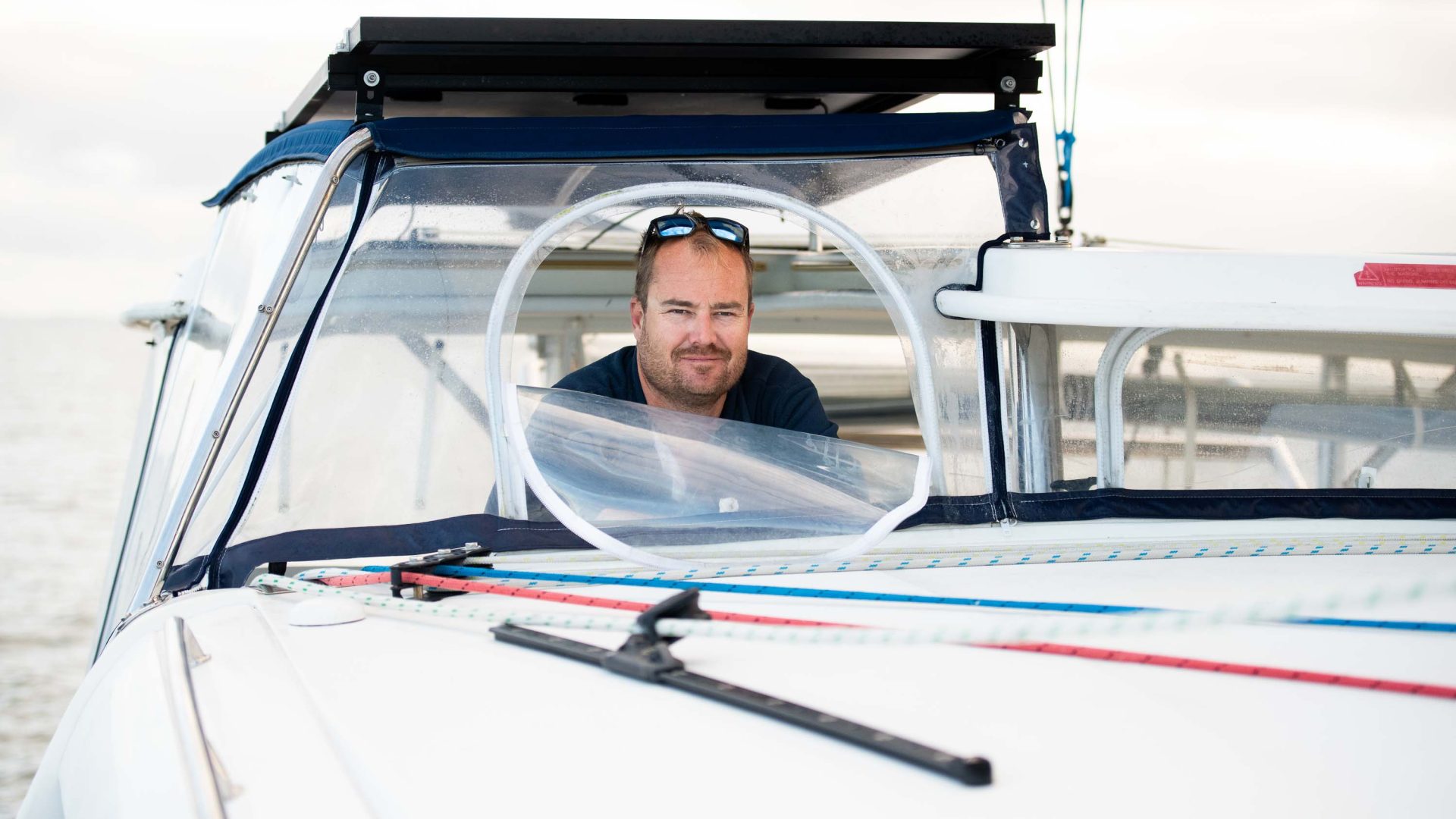A man looks out from the boat he is in.