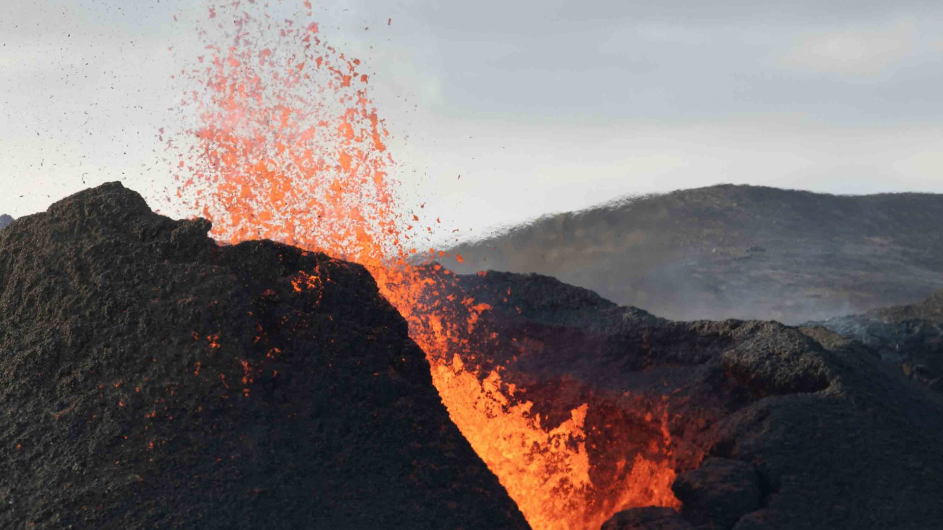 Lava flows down the wall of a volcano.