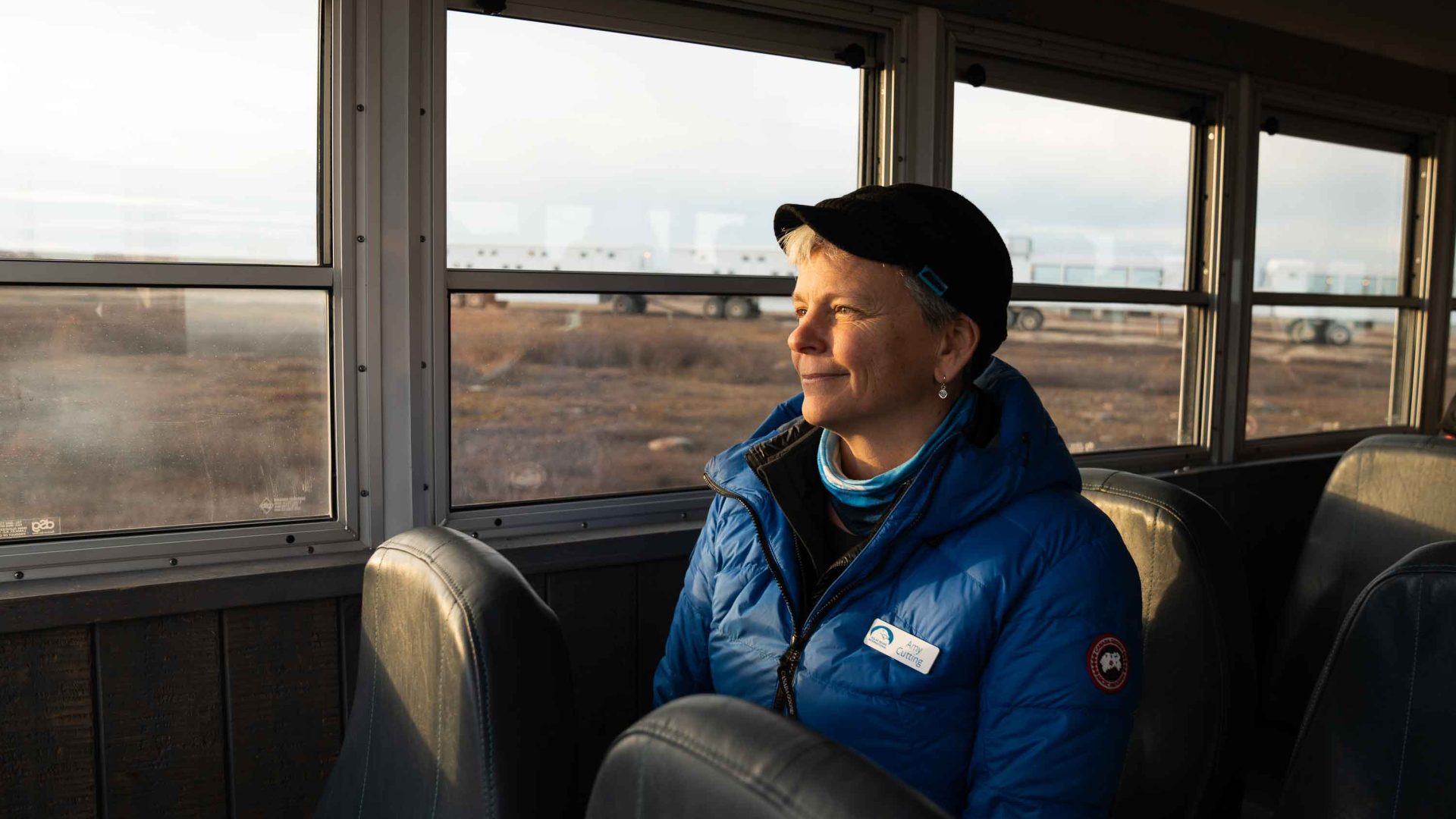 A woman looks out the window of a buggy.