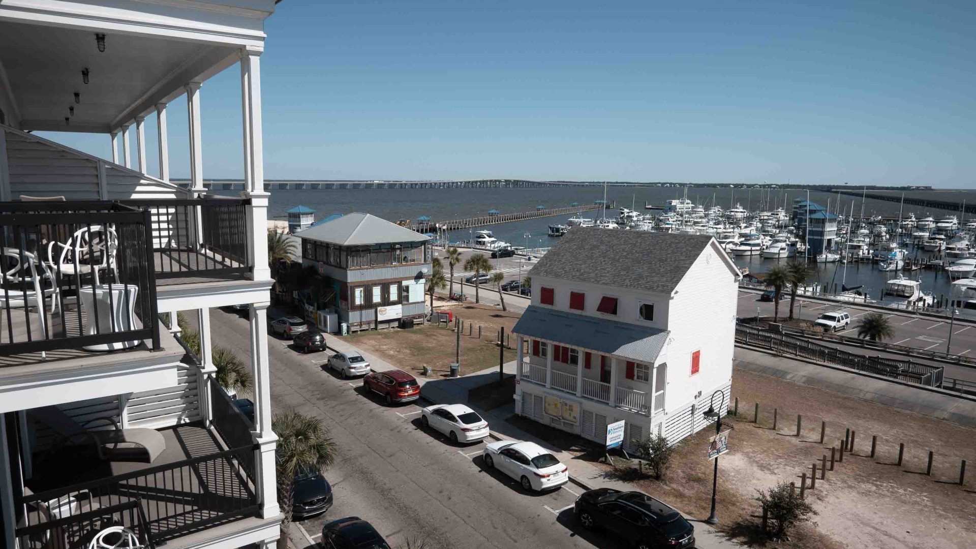Looking down at a street with some buildings and water in the distance.