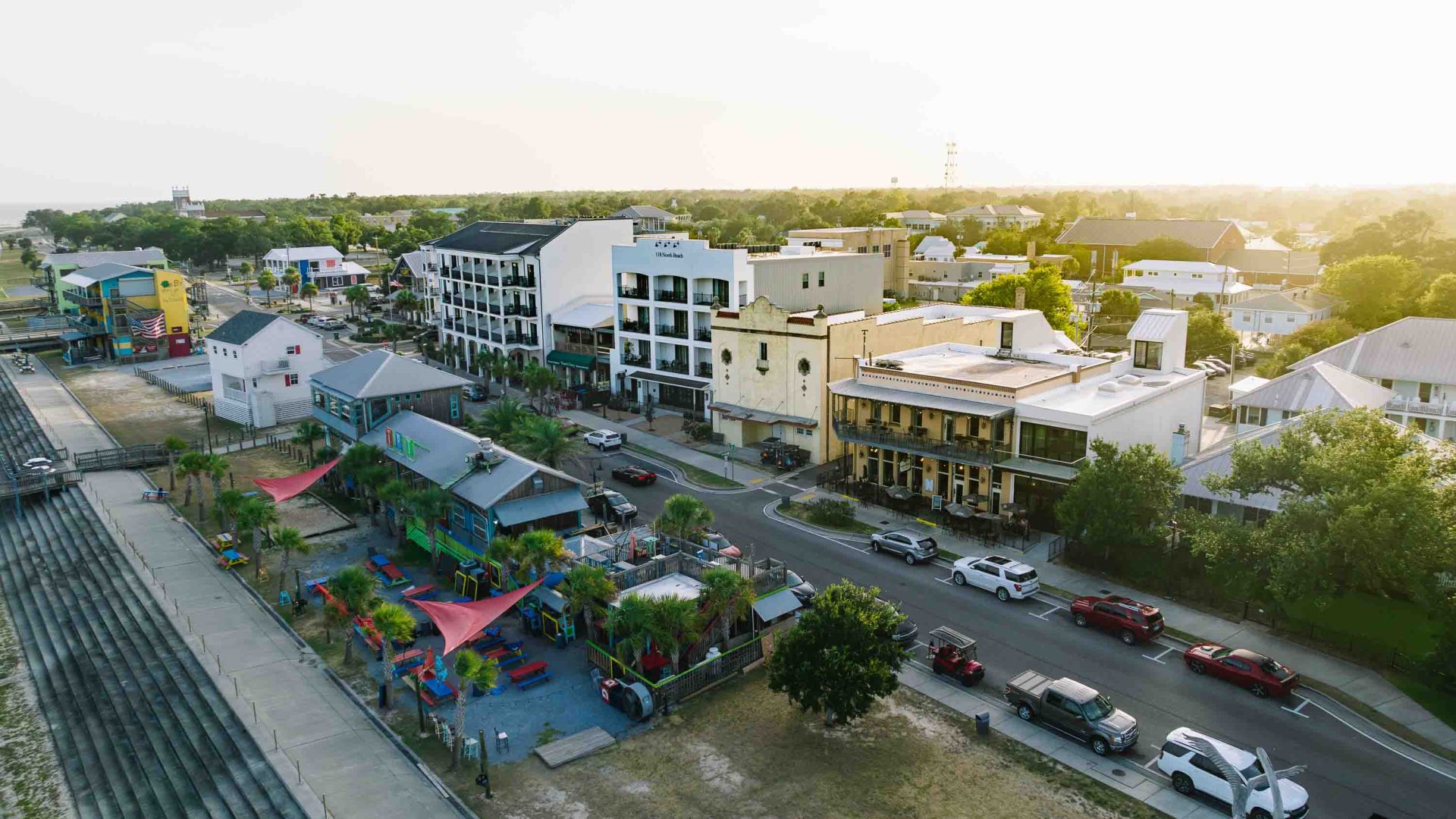 Looking down at a street with shops and trees.