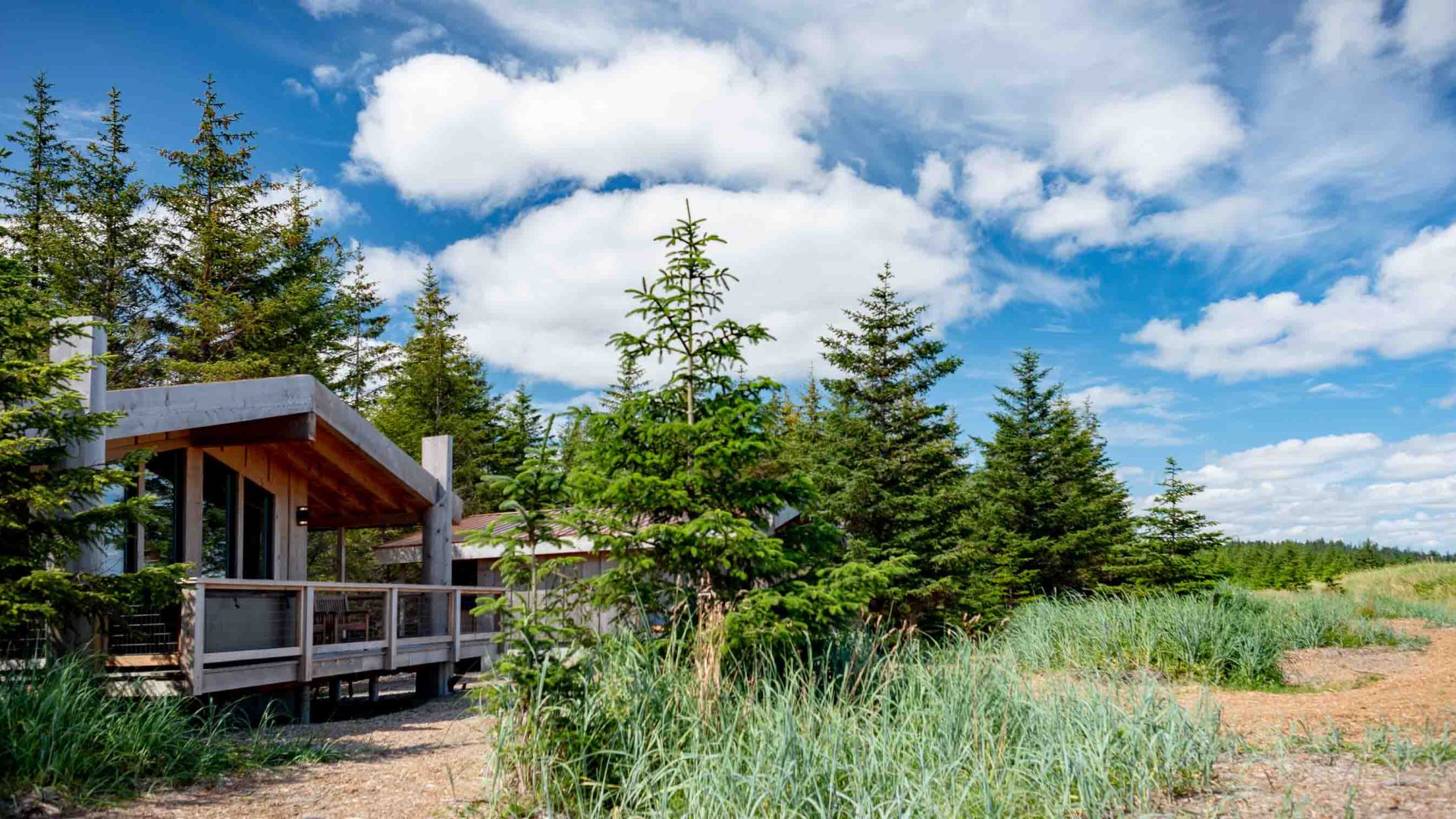 A hotel looks out at trees and field.