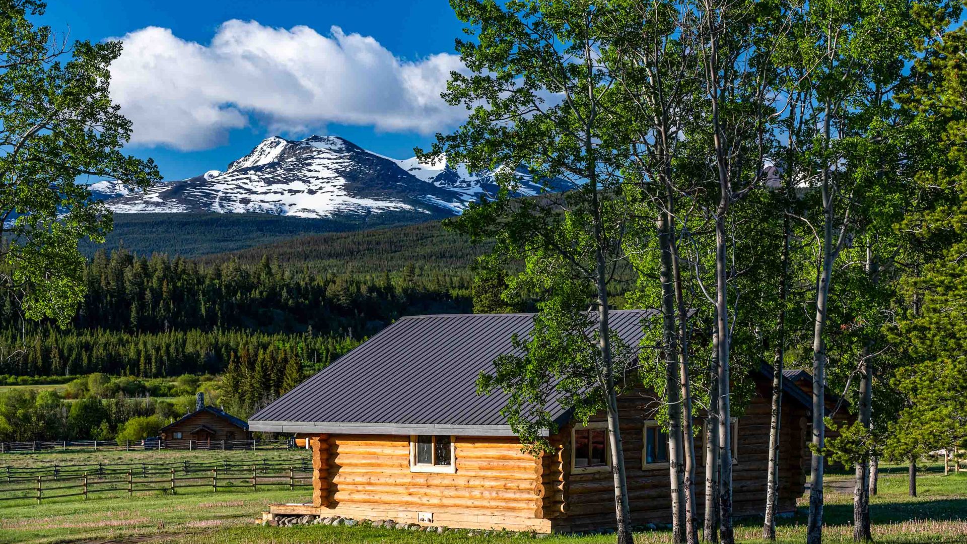 A small lodge with views of snowy mountains.