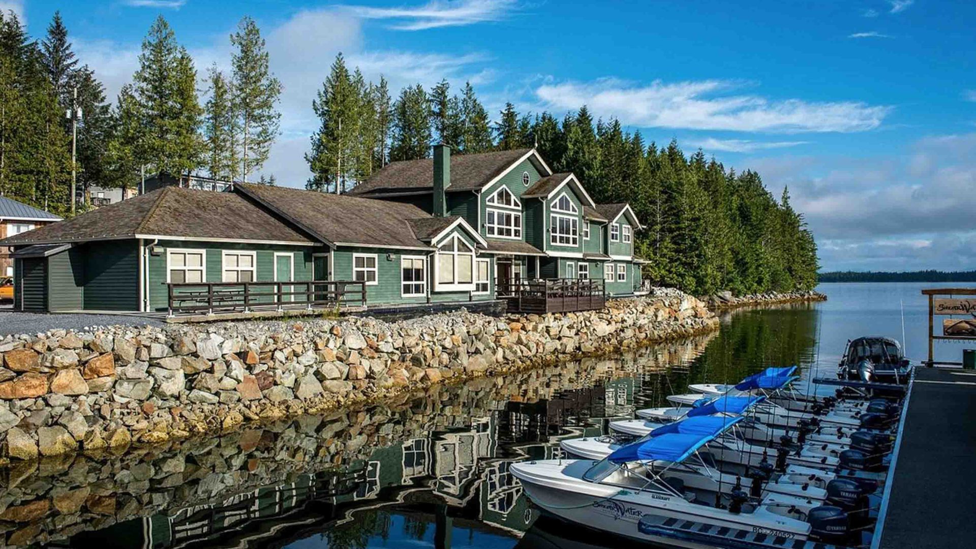A resort on the edge of a mariner with small boats in it.