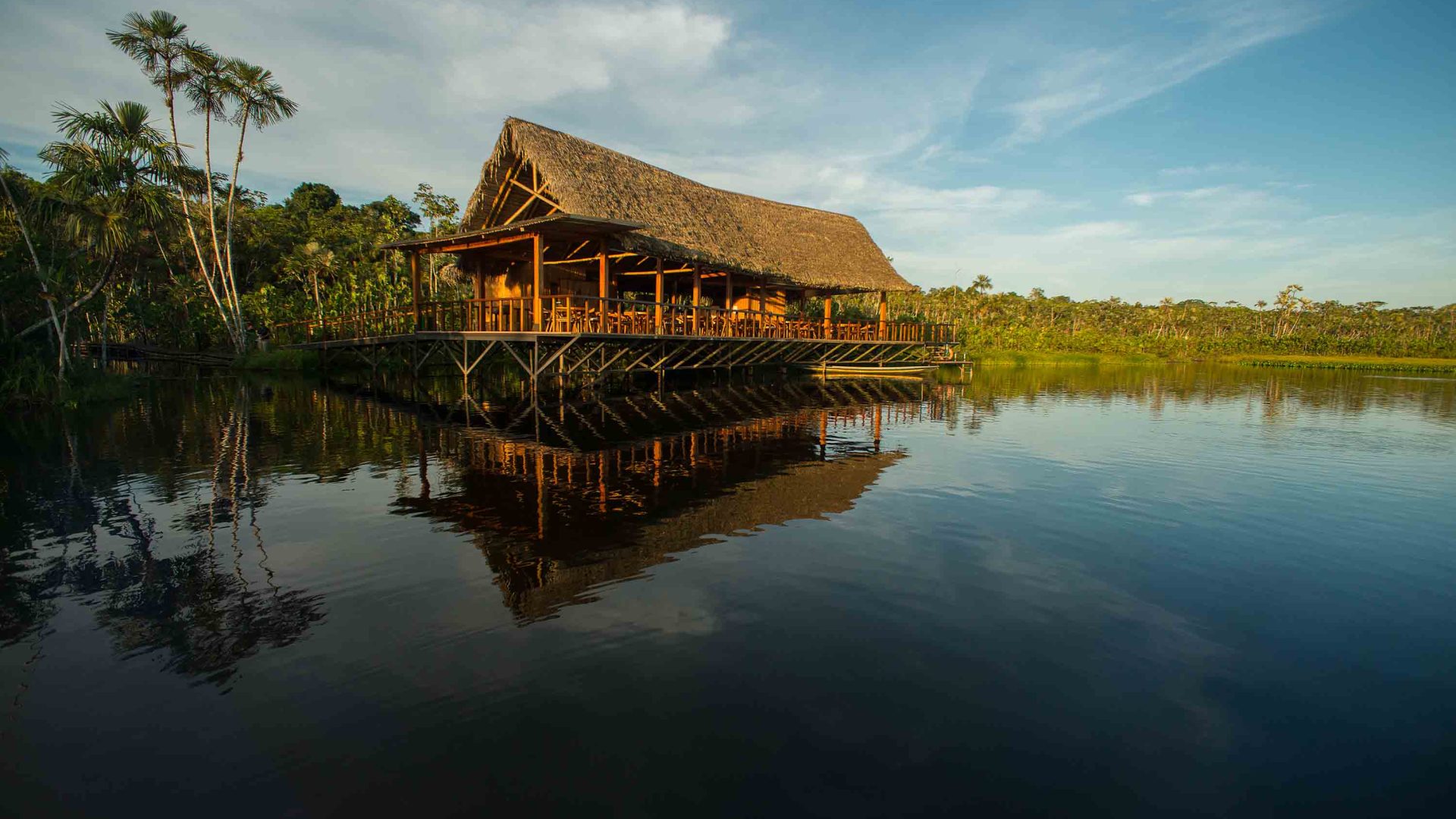 A lodge on the edge of a lake.