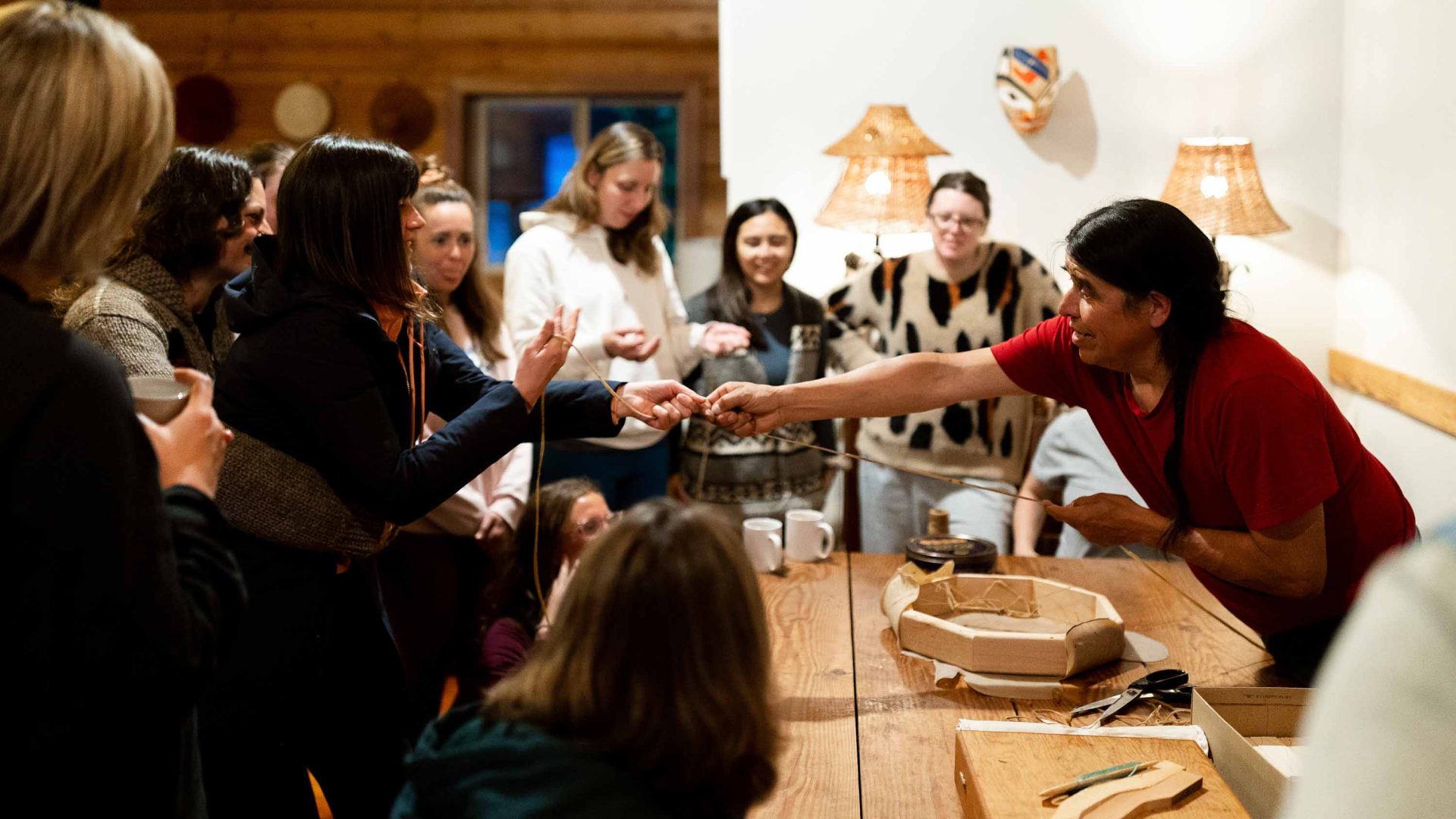 Guests engage around a table.