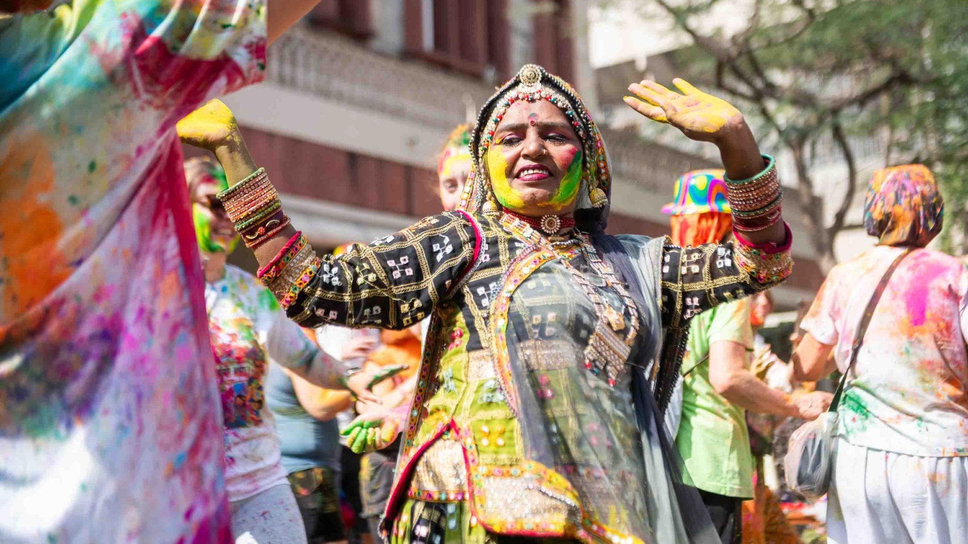 A woman dances during a holi festival.