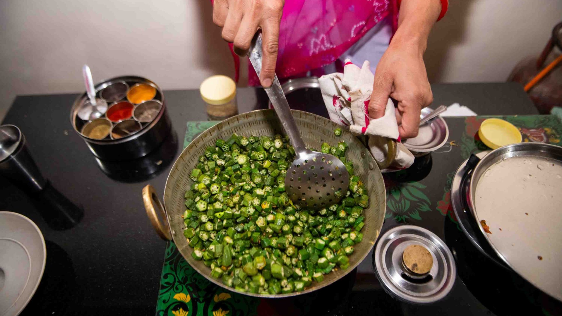 An okra dish is prepared in a pan.