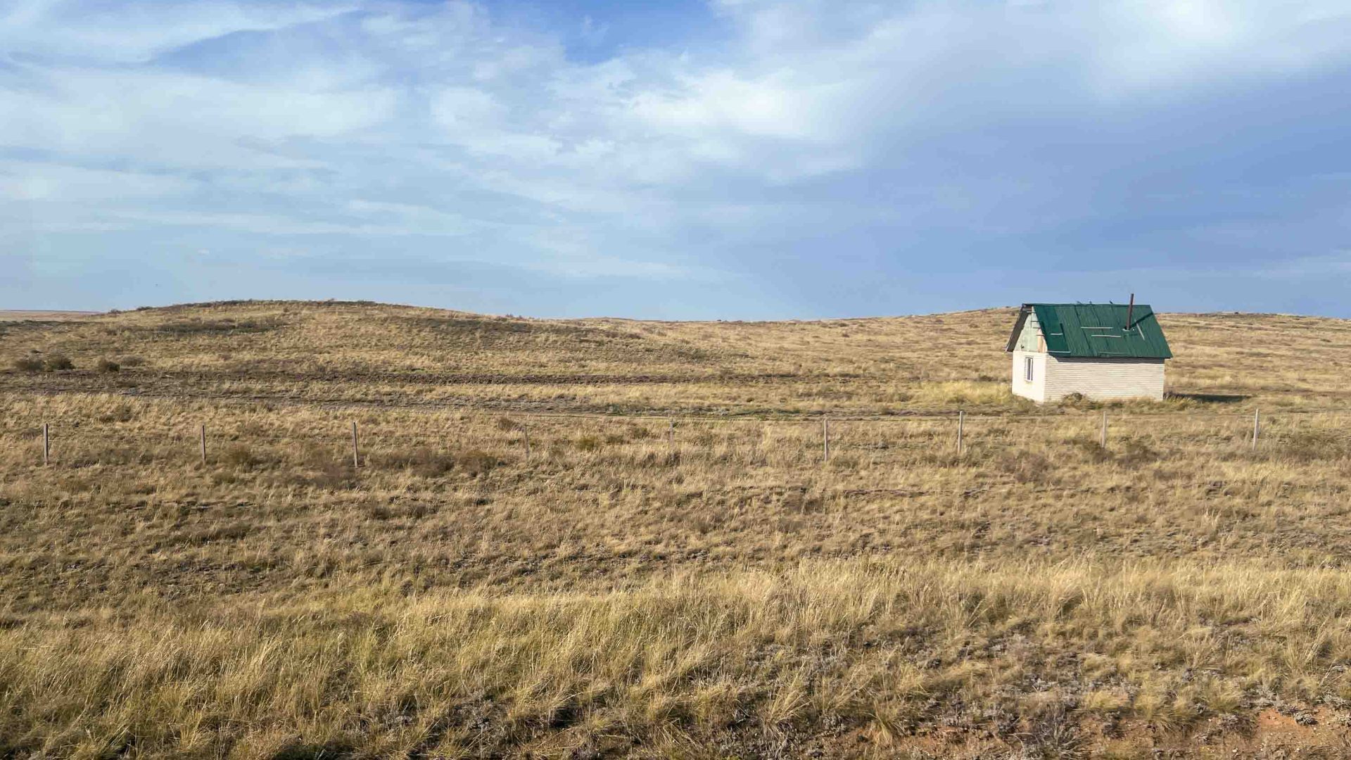 A view of a house in a field.