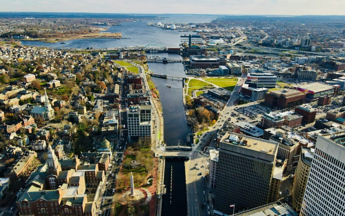 Aerial photo of Fox Point and down Providence, Rhode Island, on a sunny day, showing the Providence River as it empties out into the Narragansett Bay.