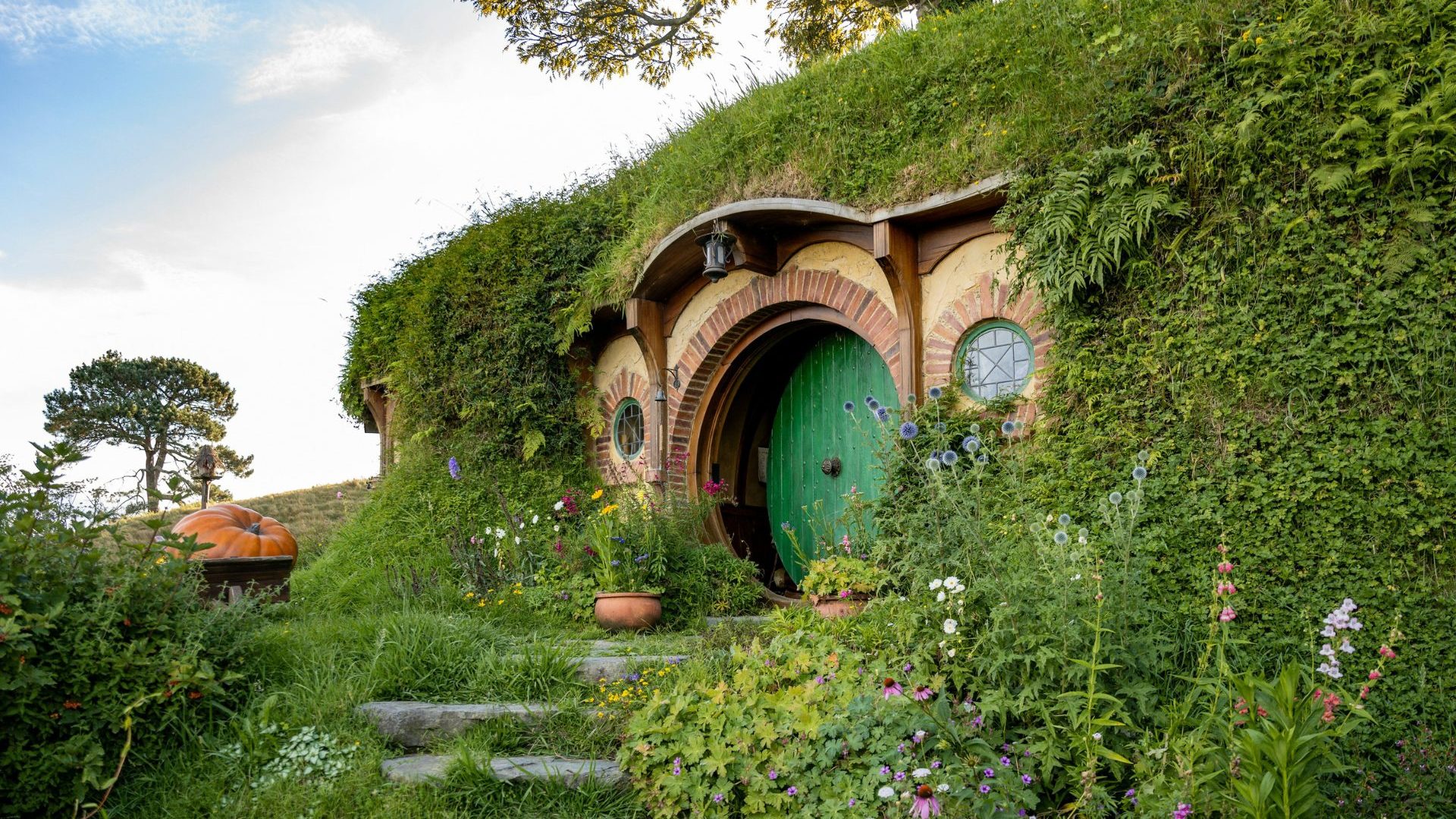 Hobbit house set against green hill
