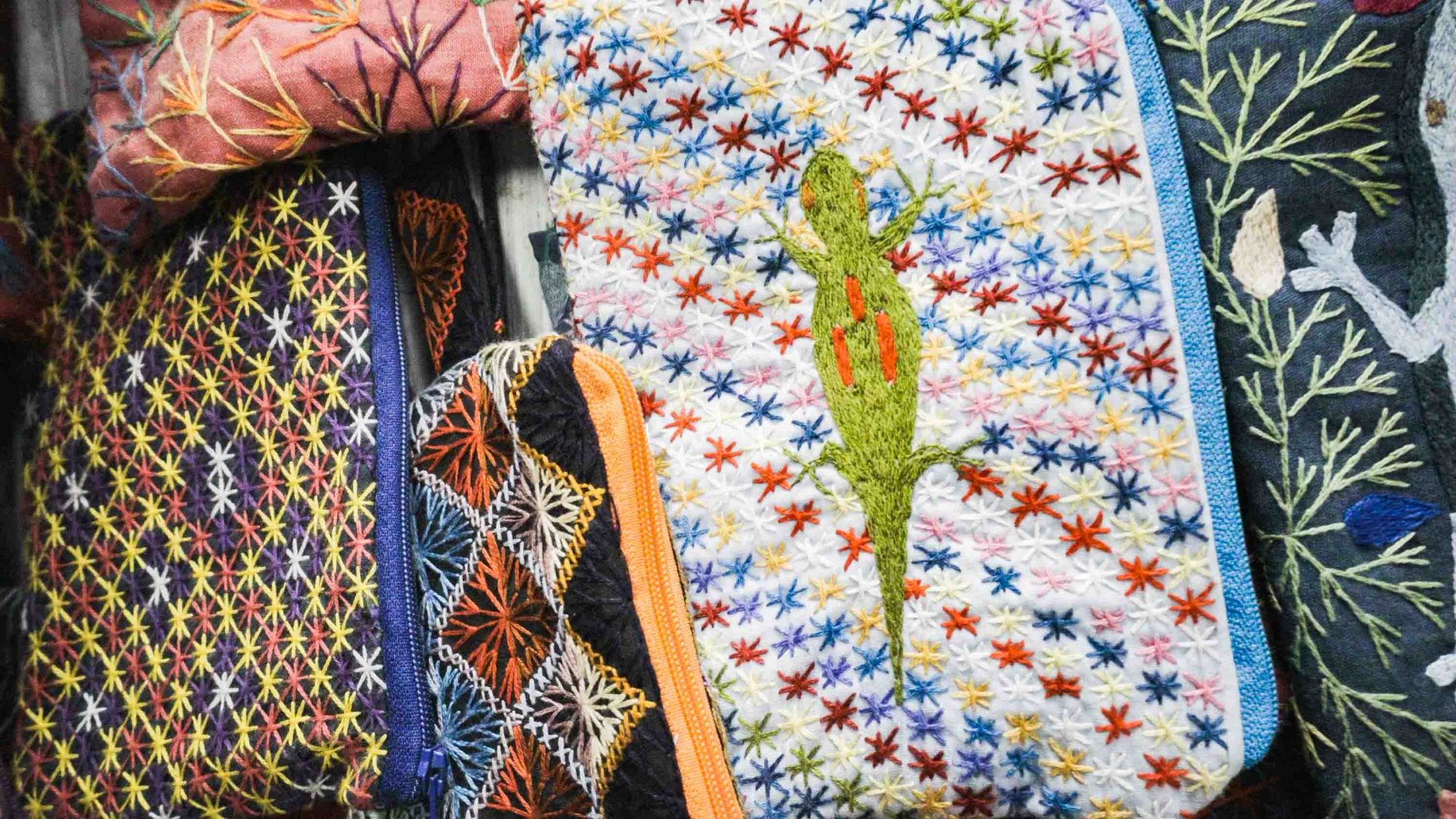 A handicraft with an embroidered gecko on it.