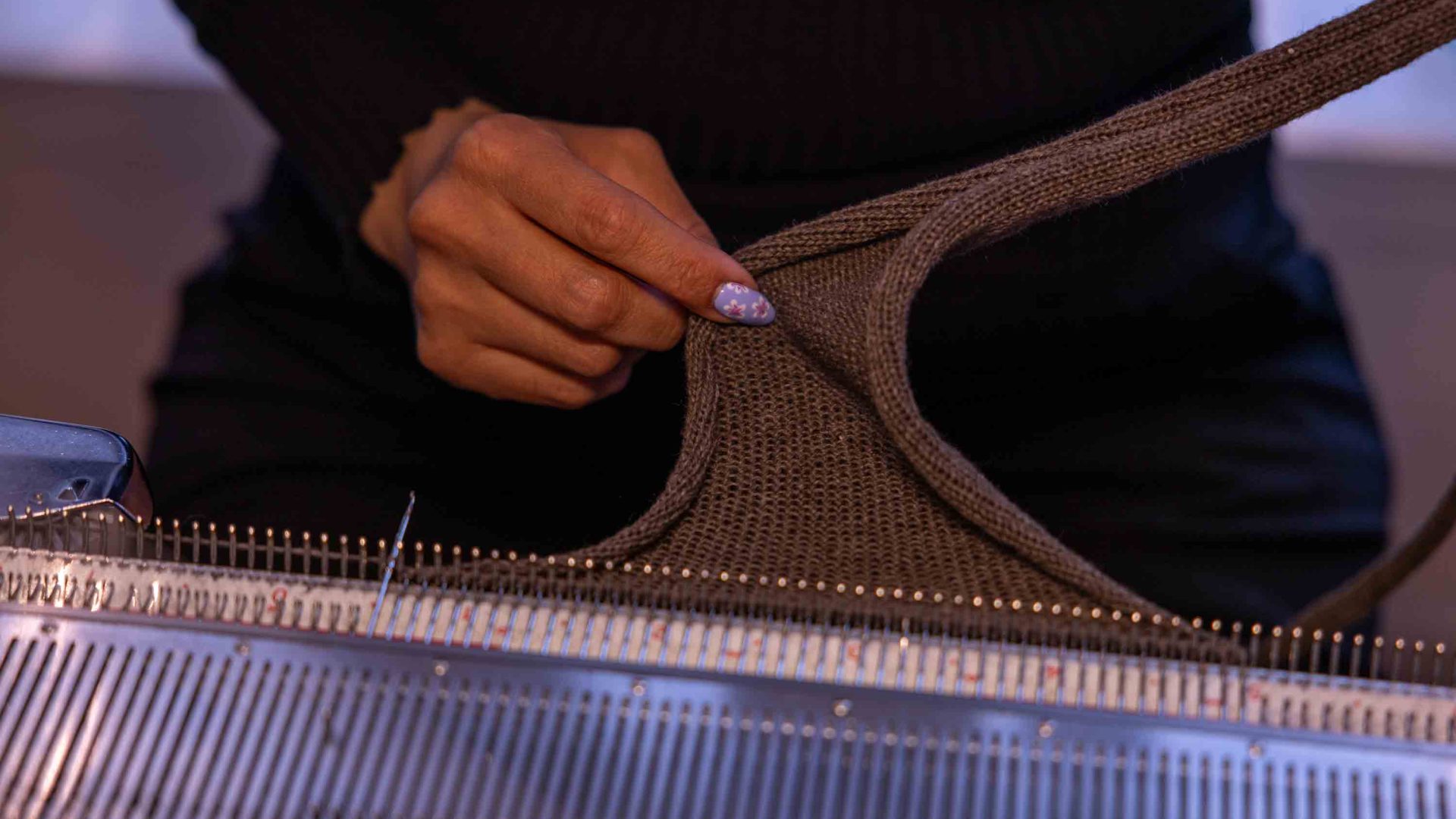 A woman's hands yarn brown wool.