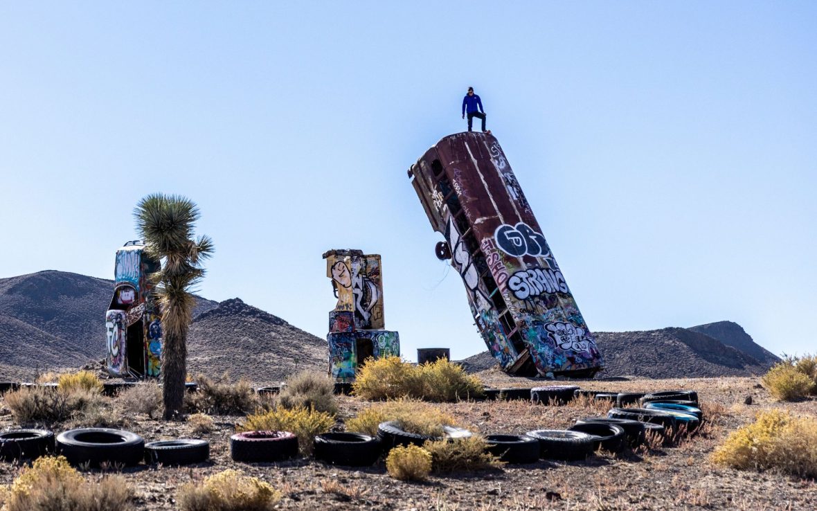 Alex Honnold stands atop a vertical bus at Carhenge in Nevada