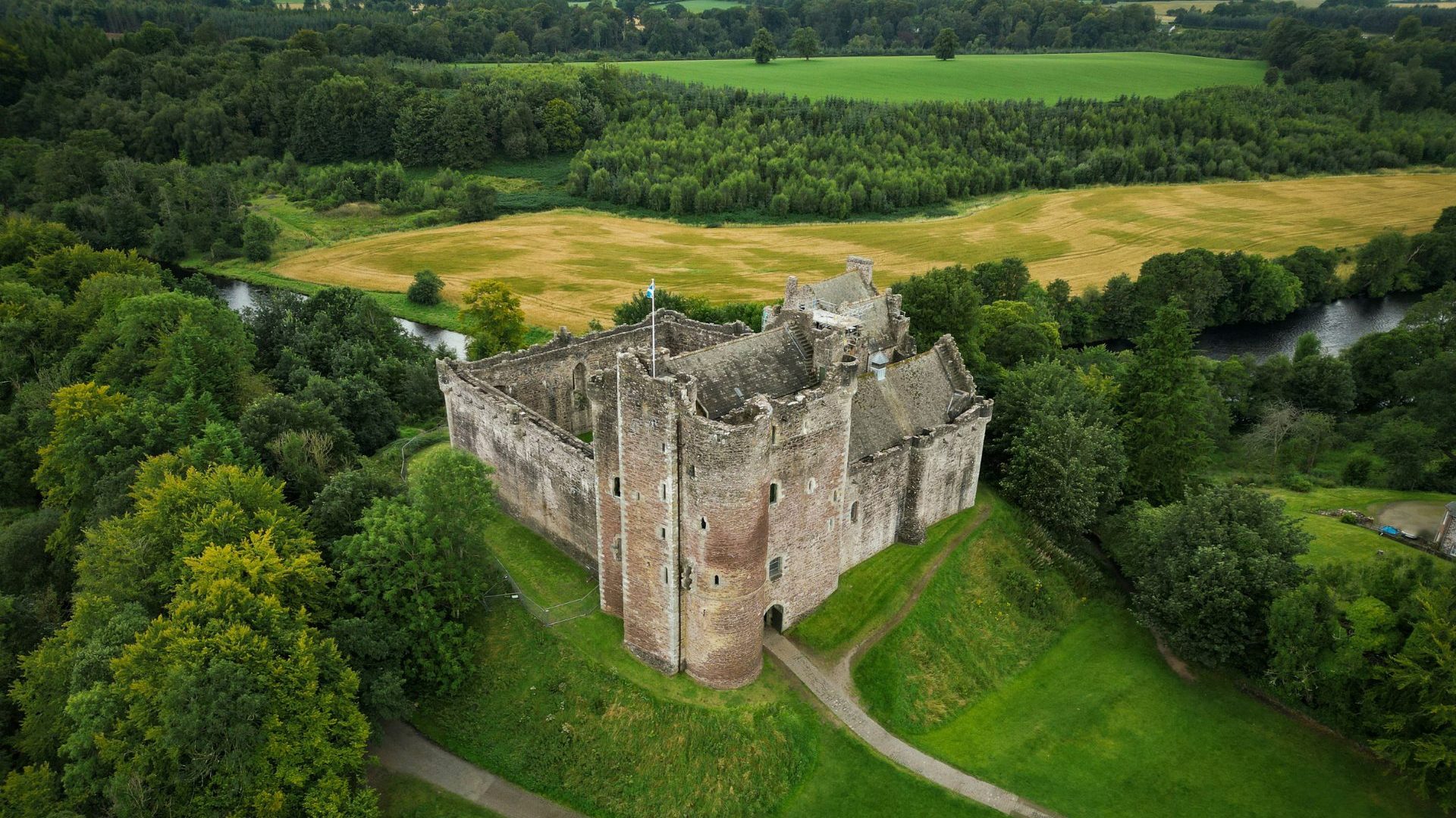 Grey castle on green landscape