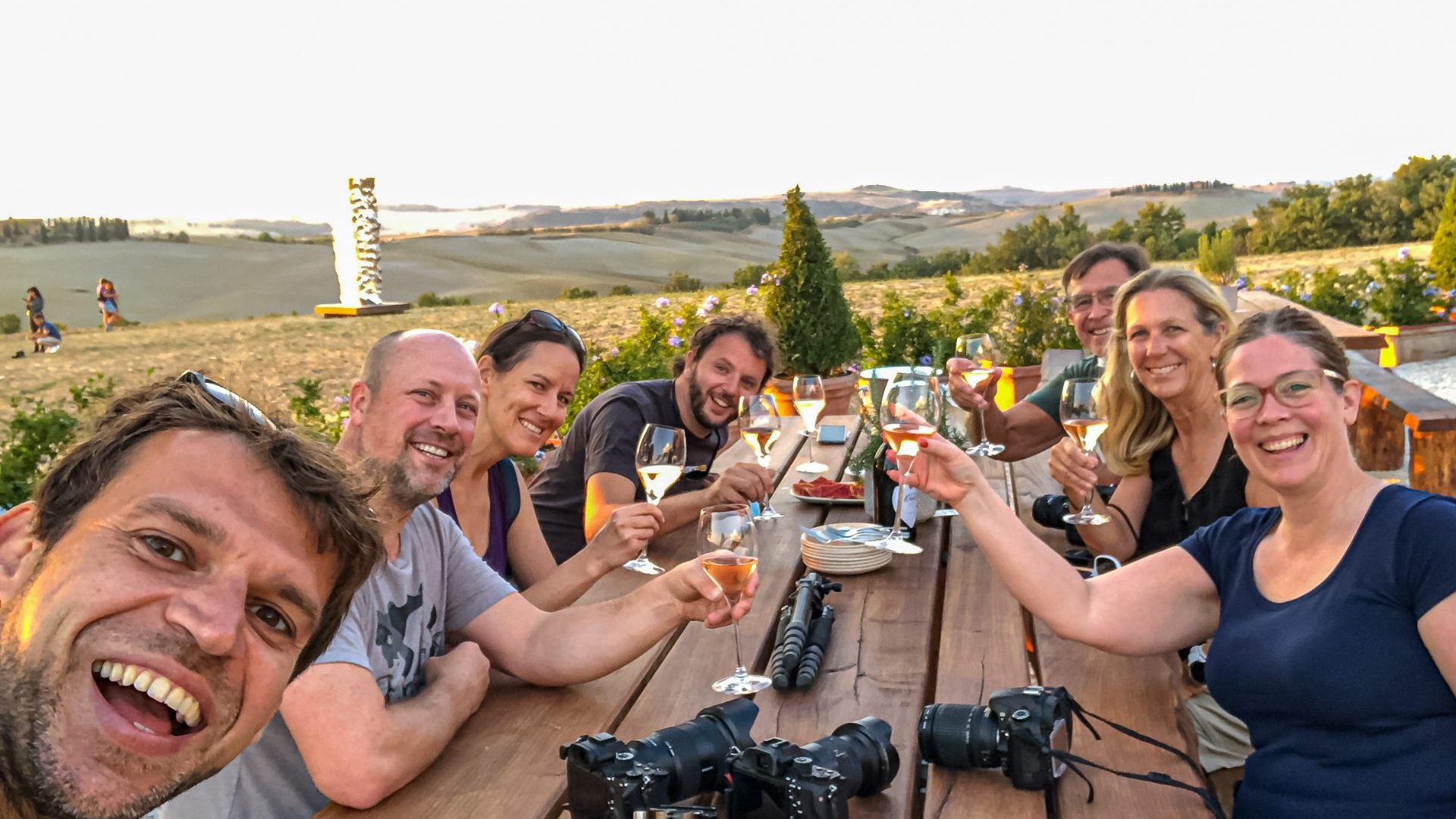 Group of people 'cheers' with wine.