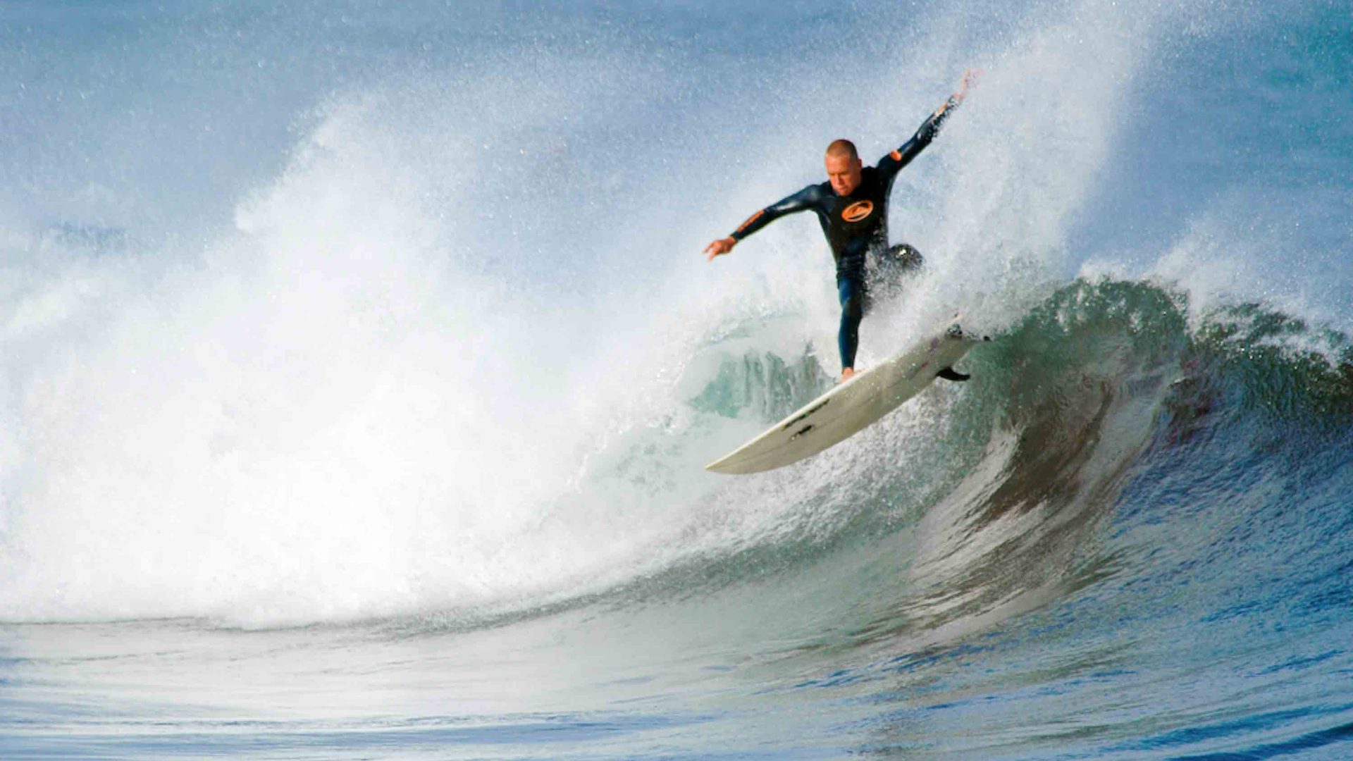 A surfer rides a wave.