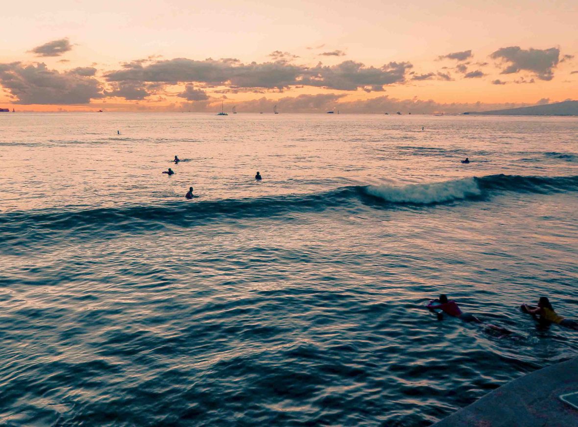 Surfers at sunset.