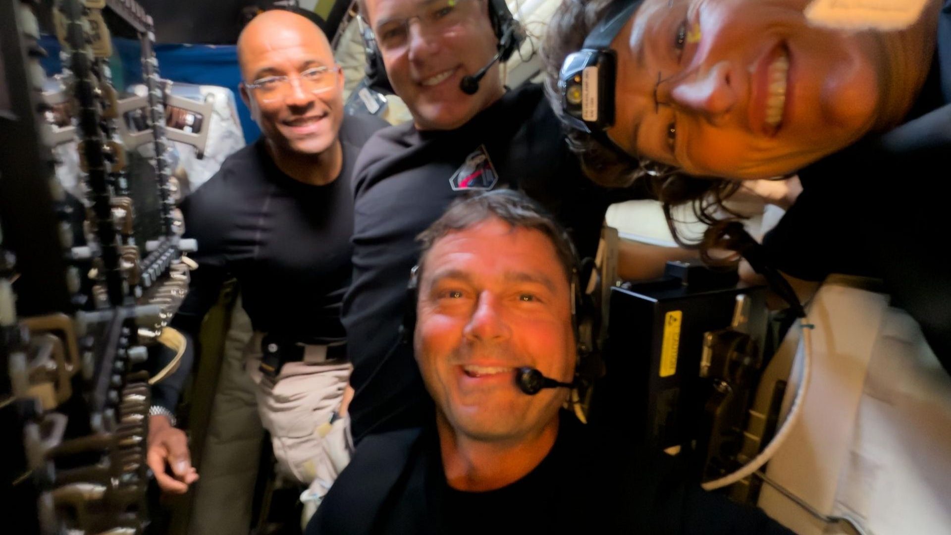 Midway through their lunar observation period, the Artemis II crew members – Reid Wiseman, Victor Glover, Christina Koch, and Jeremy Hansen – pause to turn the camera around for a selfie inside the Orion spacecraft.
