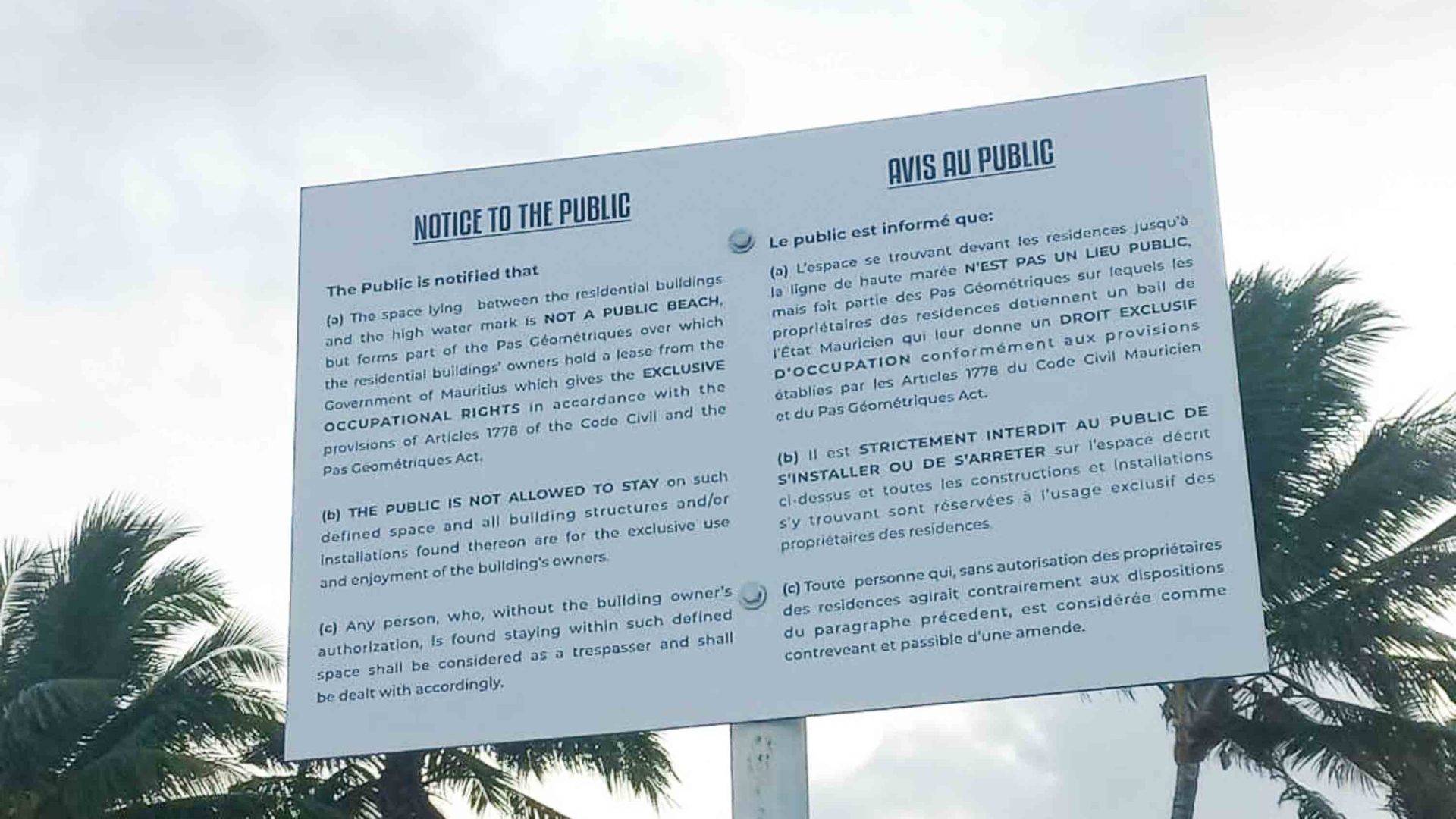 A sign explains lack of access to the beach being owing to a leasing agreement with the Government.