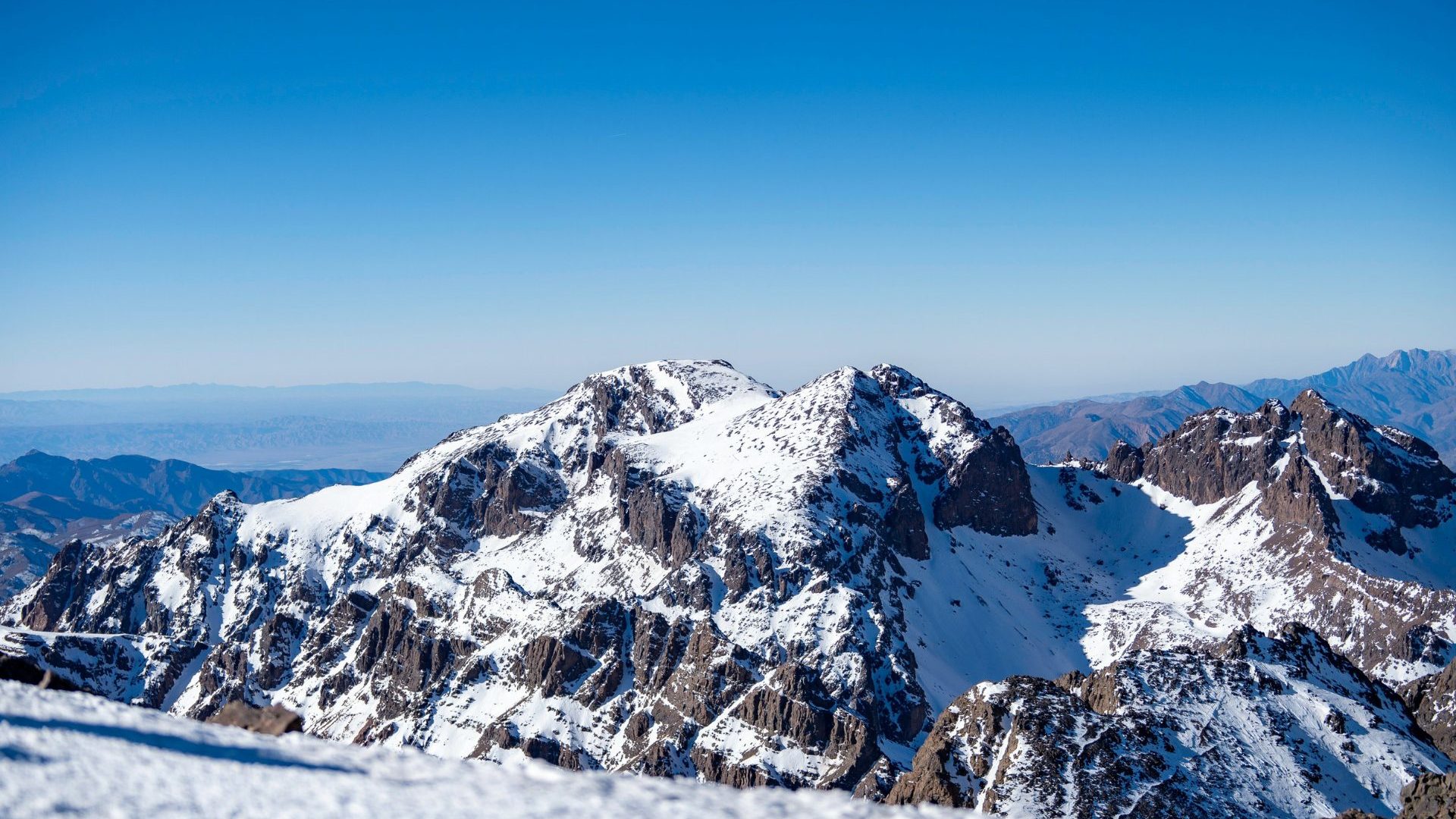 Snowcapped peak against blue sky.