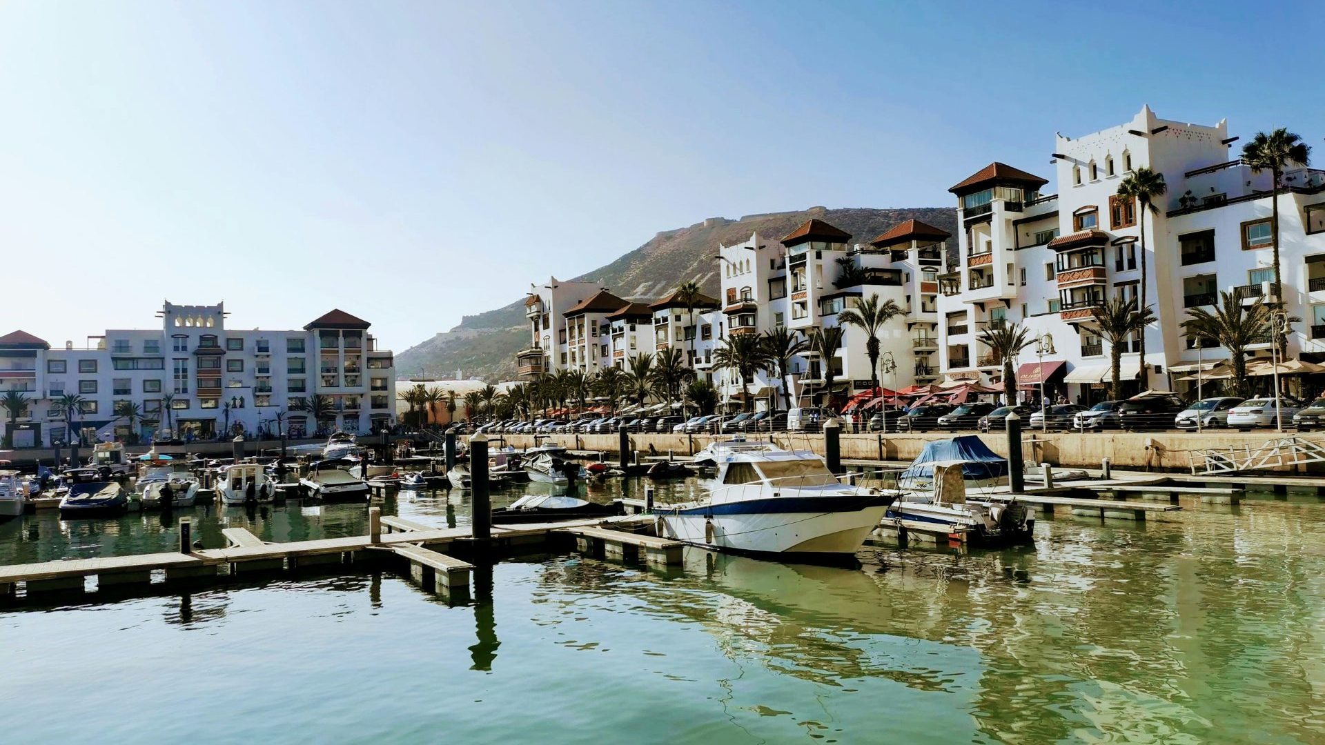 Boats dock in water under blue skies