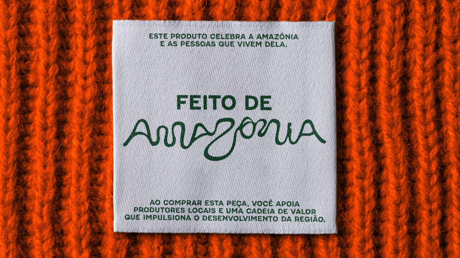 Orange knit with tag saying 'Feito de Amazônia’