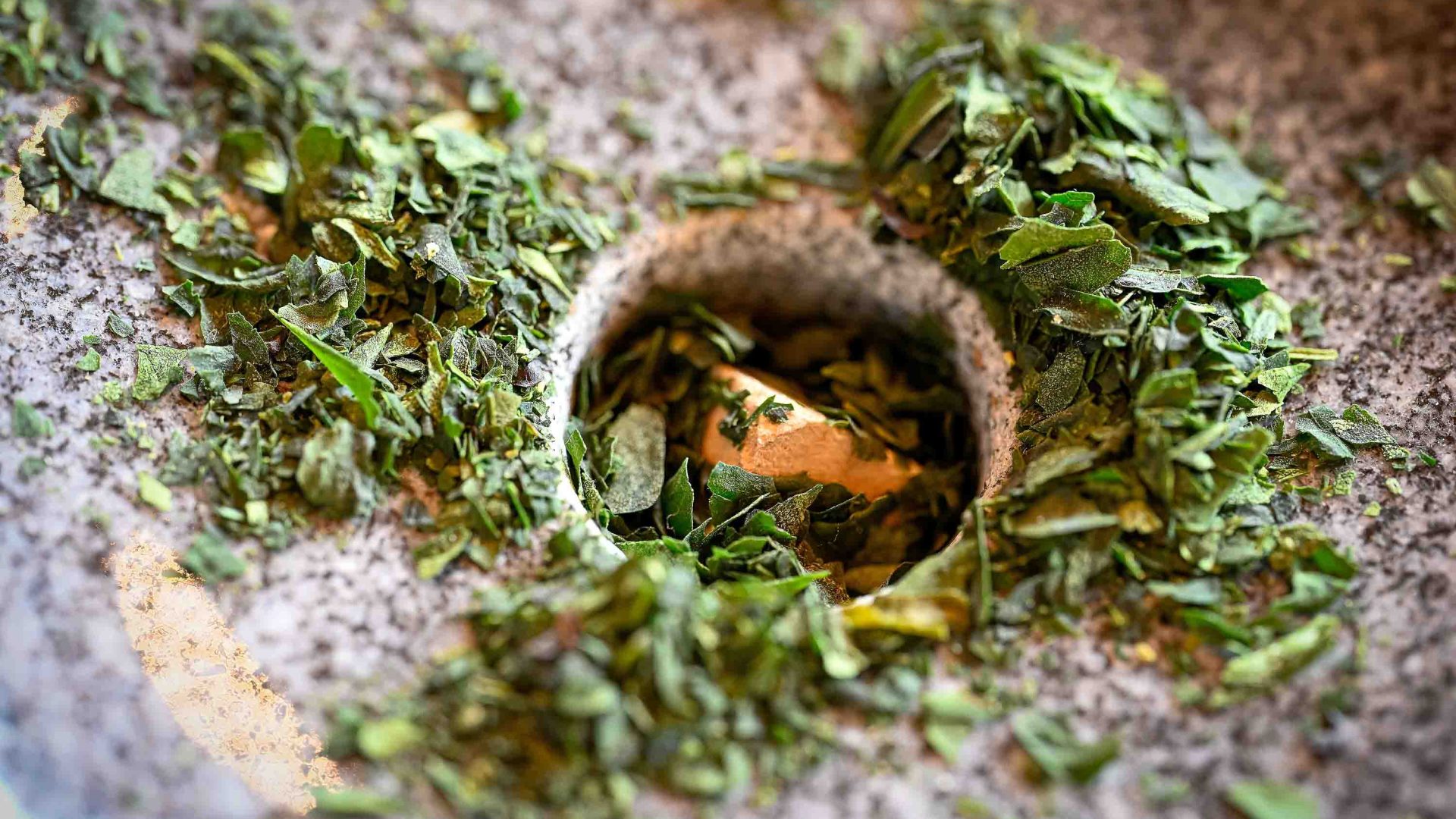 Leaves being ground on a mill.