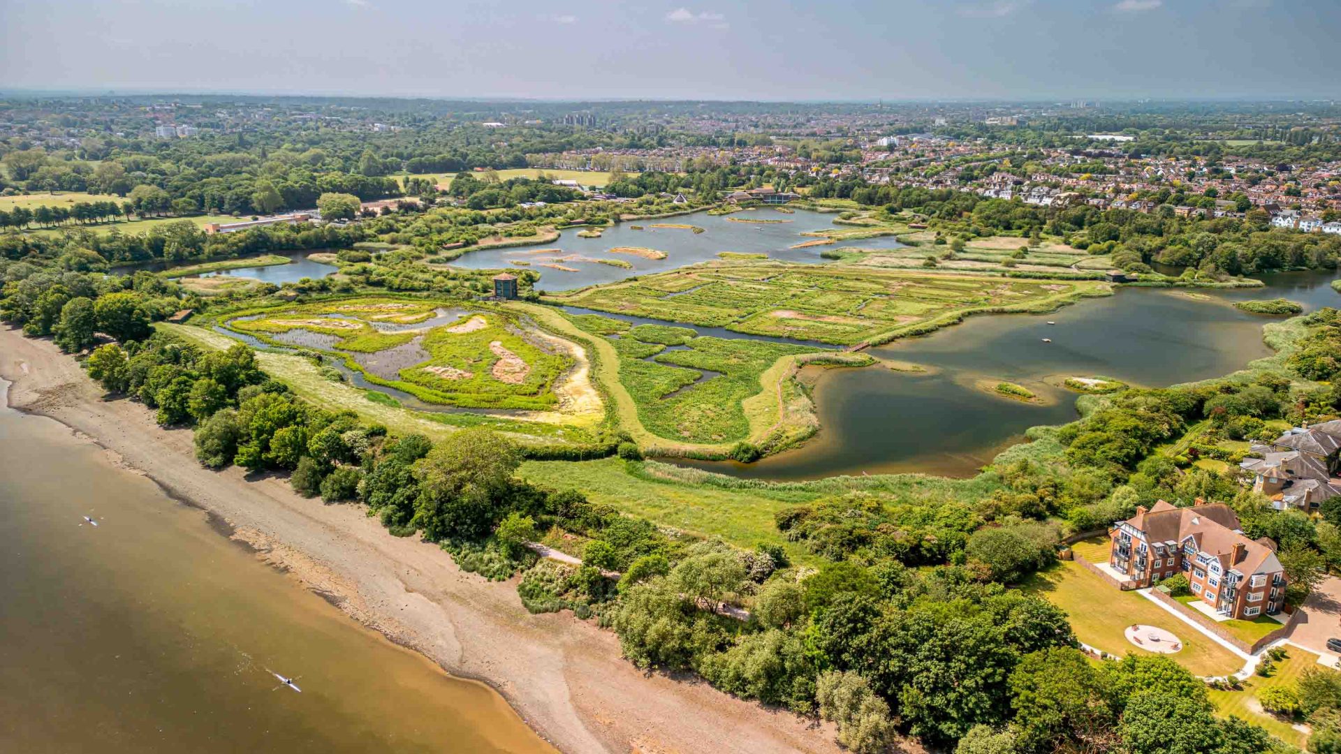 A drone photo of Wetlands and a river.
