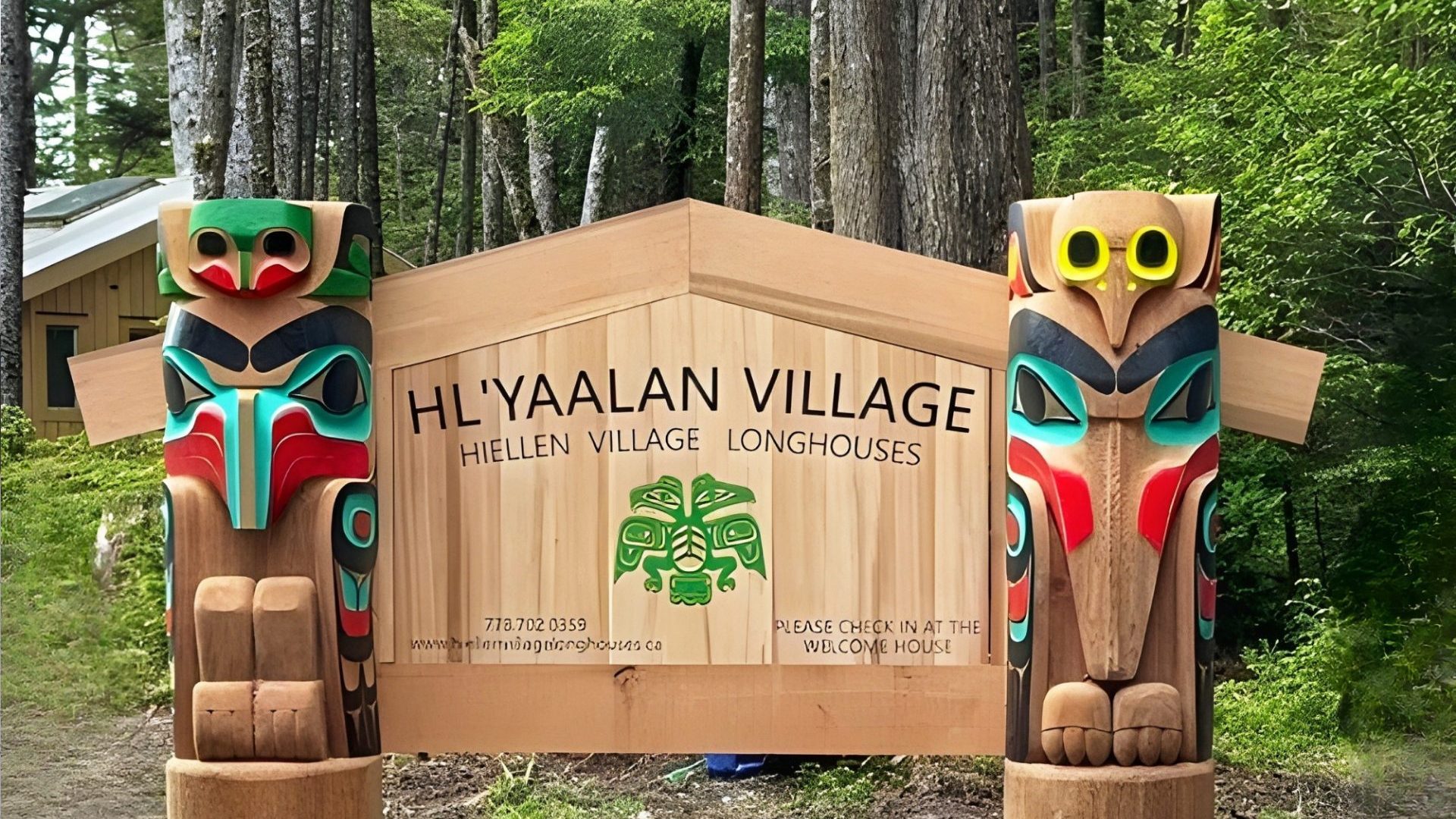 Wooden sign reading 'Hiellen Village Longhouses'.