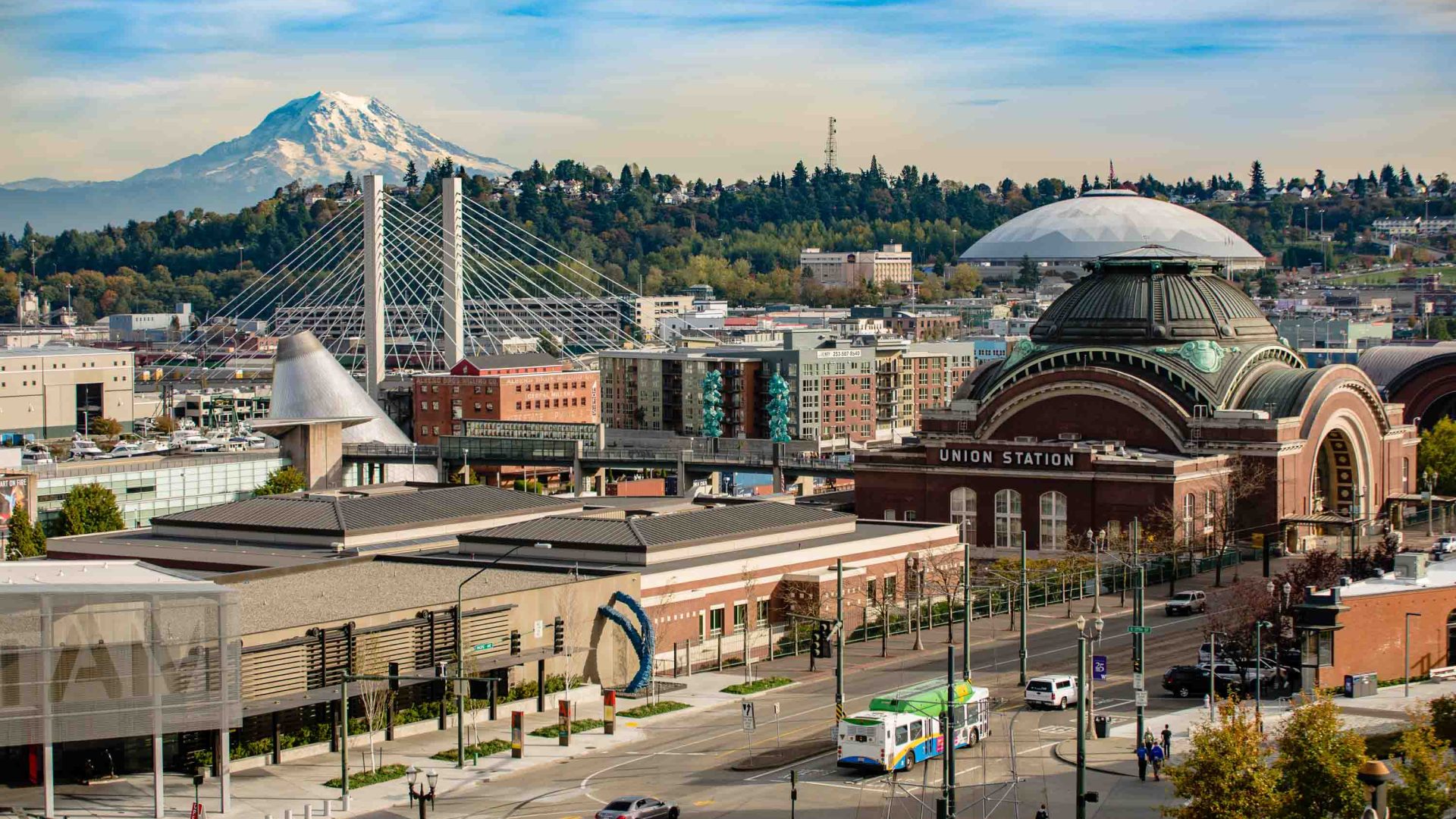 A convention centre and streets in front of a mountain.