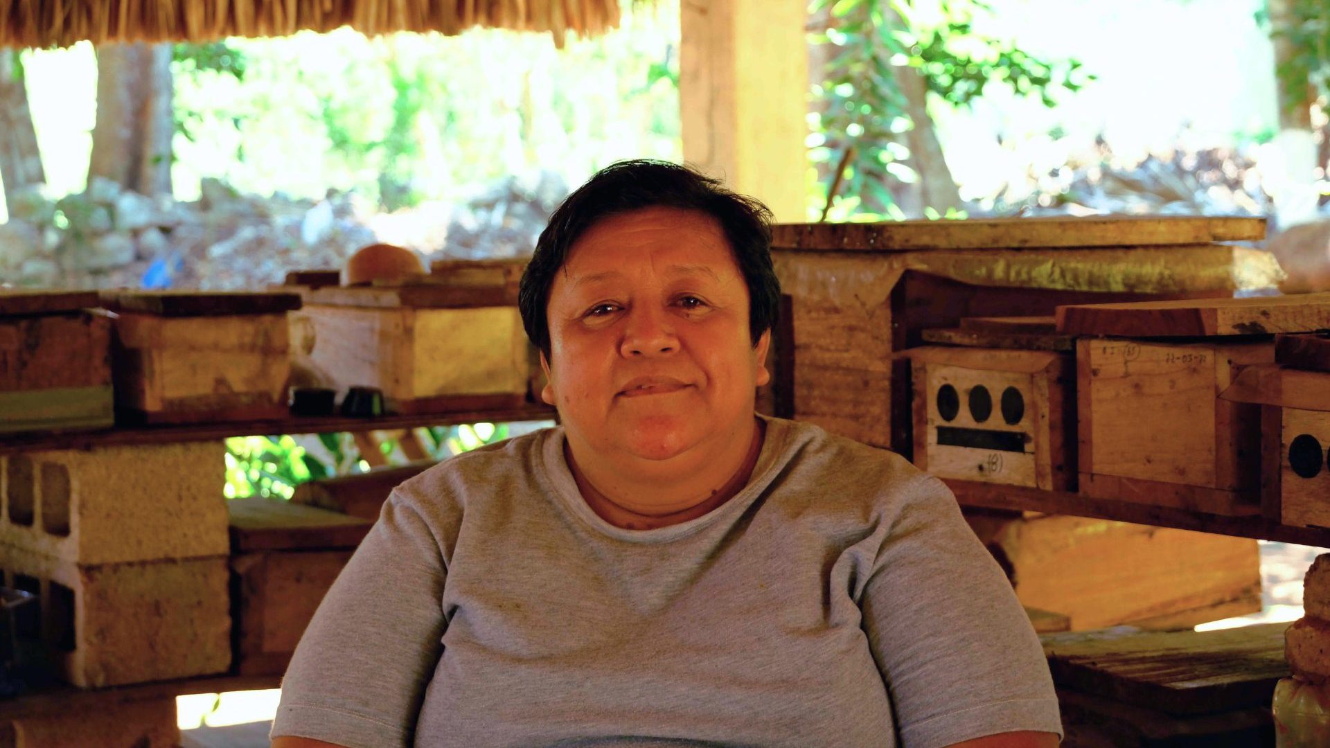 A woman with short dark hair smiles to camera