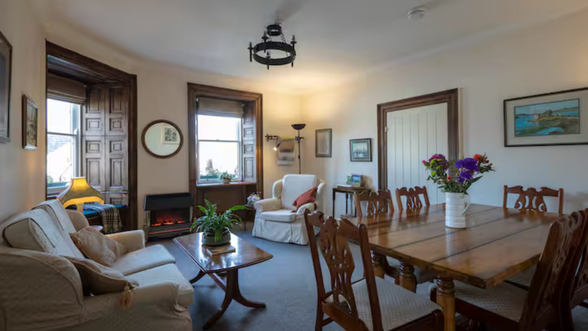 Interior of apartment with wood furniture and large armchair and couch.