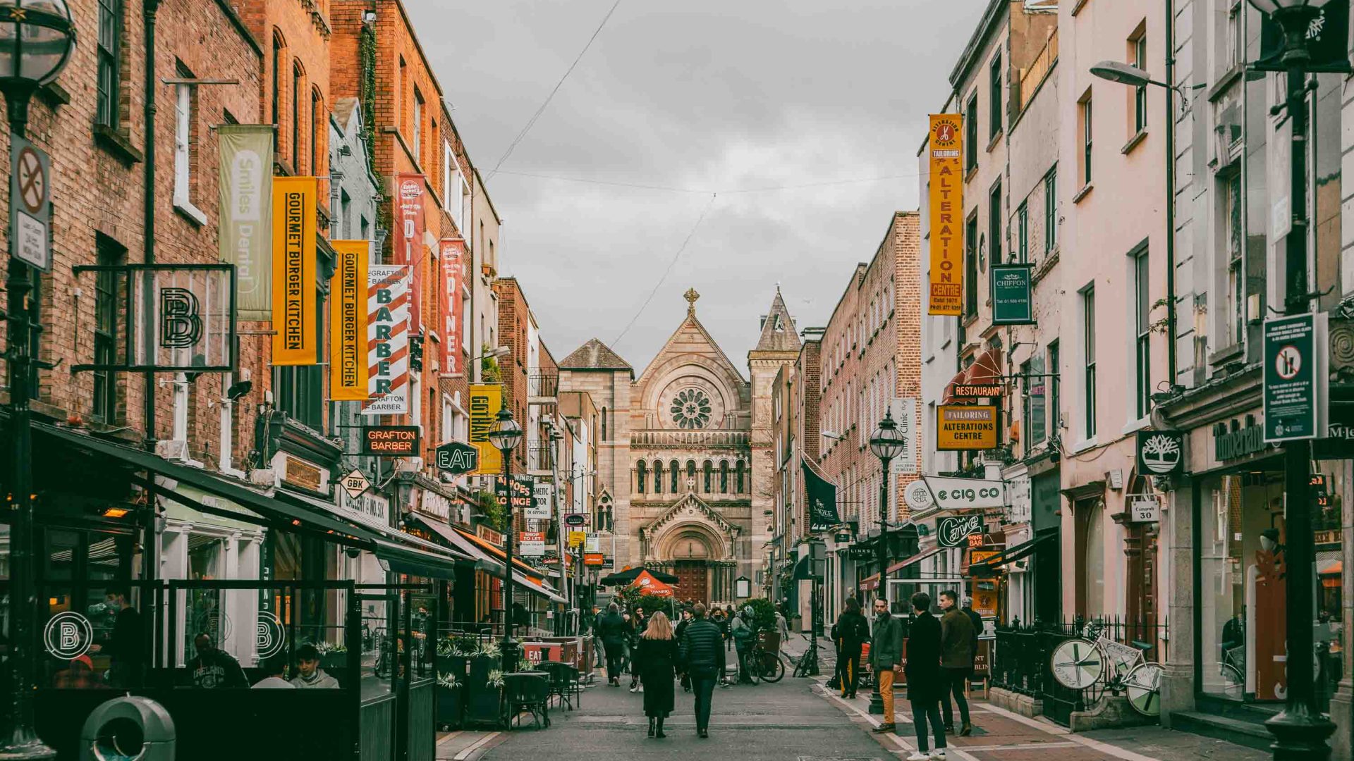 A street with shops that leads to a church.