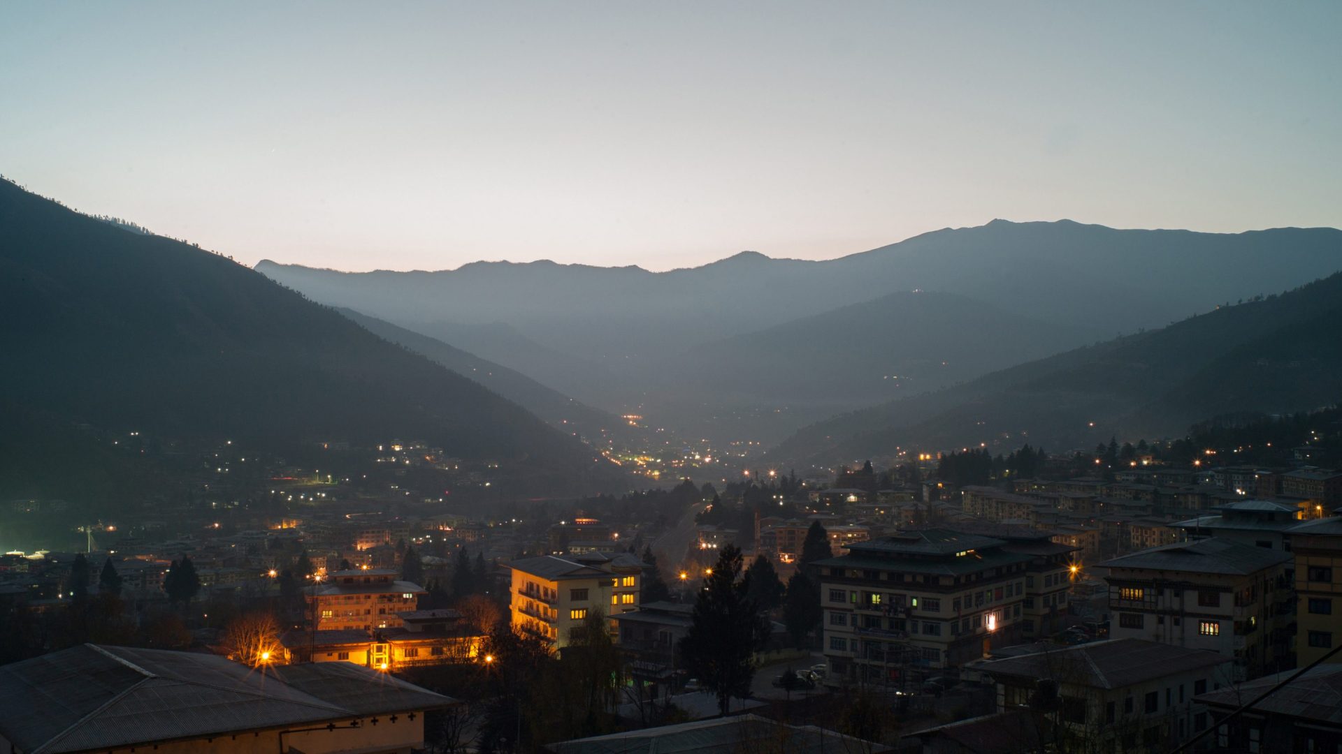 Valley at night with buildings lit up.
