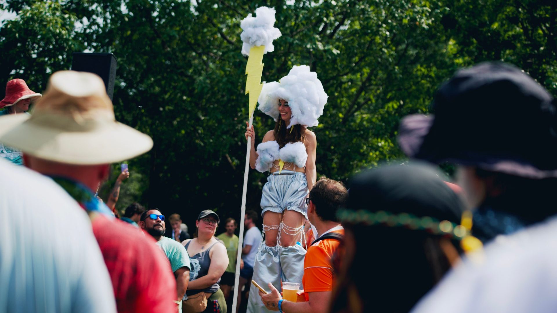 Woman on stilts in crowd.