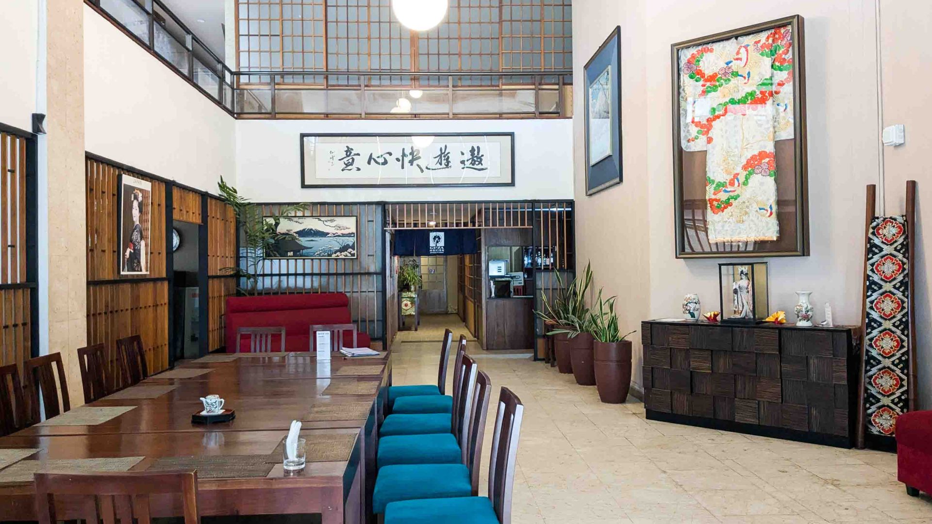 A simple interior of an empty restaurant with blue chairs.
