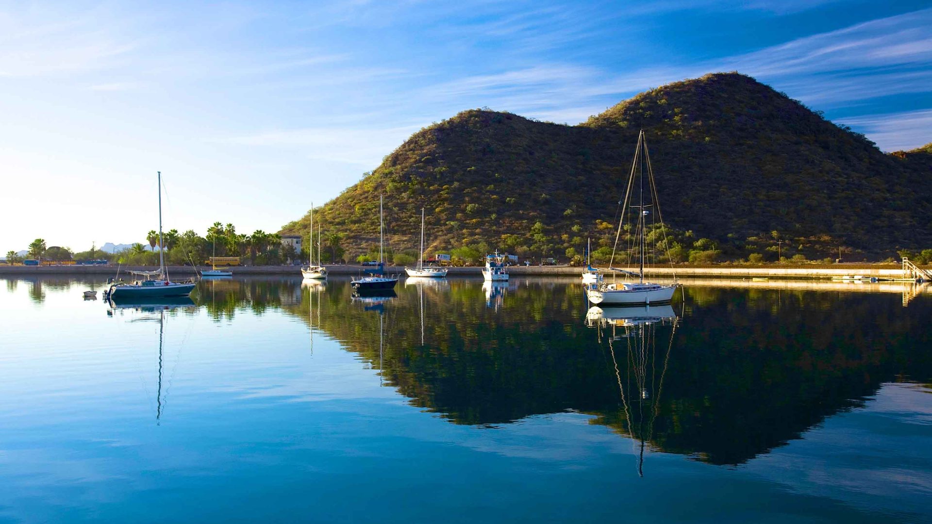 A calm body of water with boats in it.