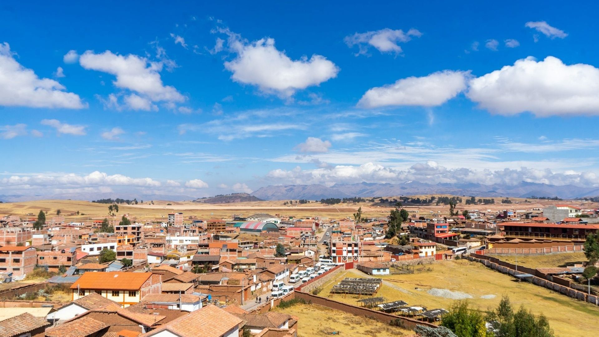 An aerial view over a town against a blue sky