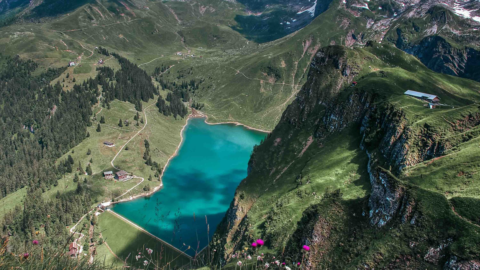 A valley leads down to a turquoise lake.