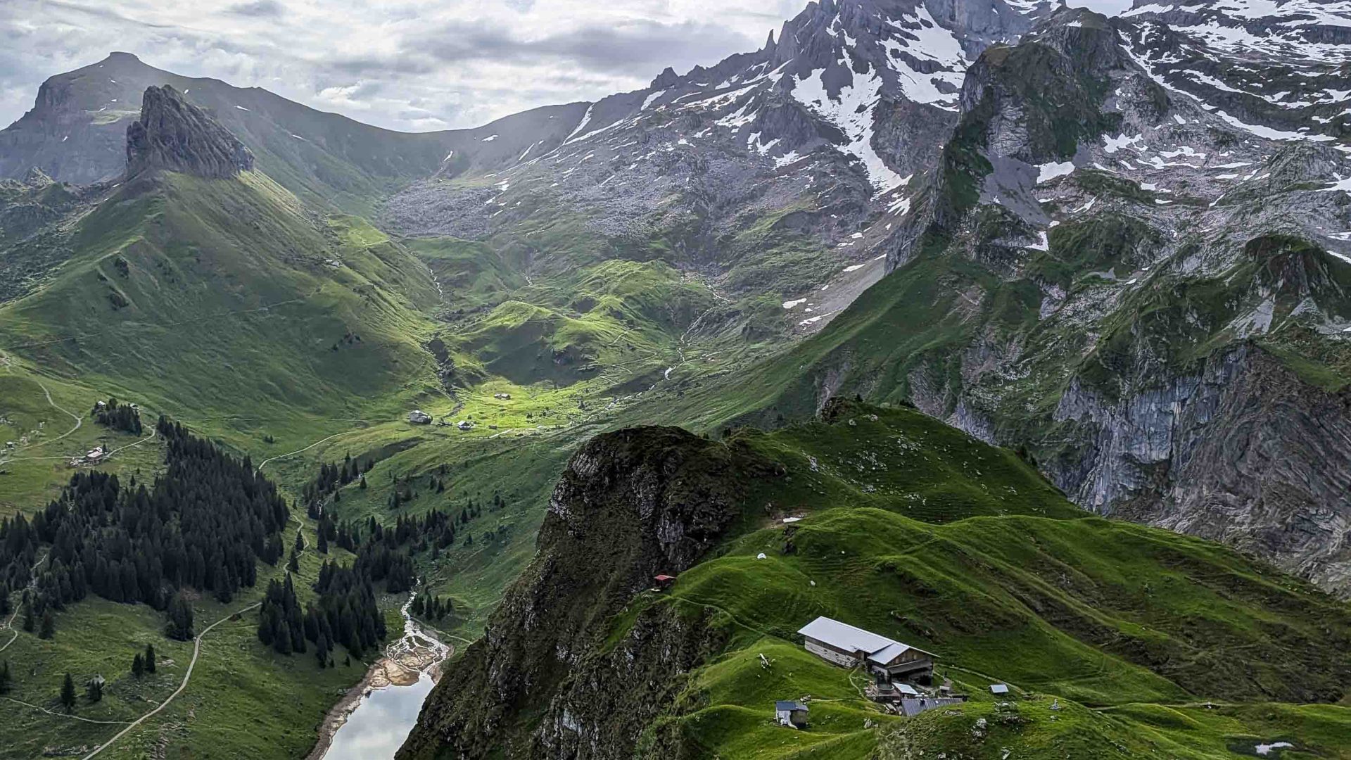Mountains drop down to a river below.
