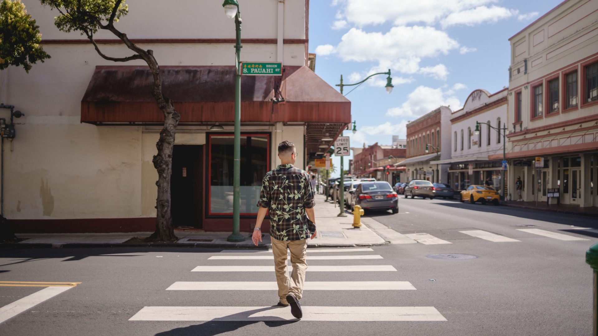Man walks a pedestrian crossing.