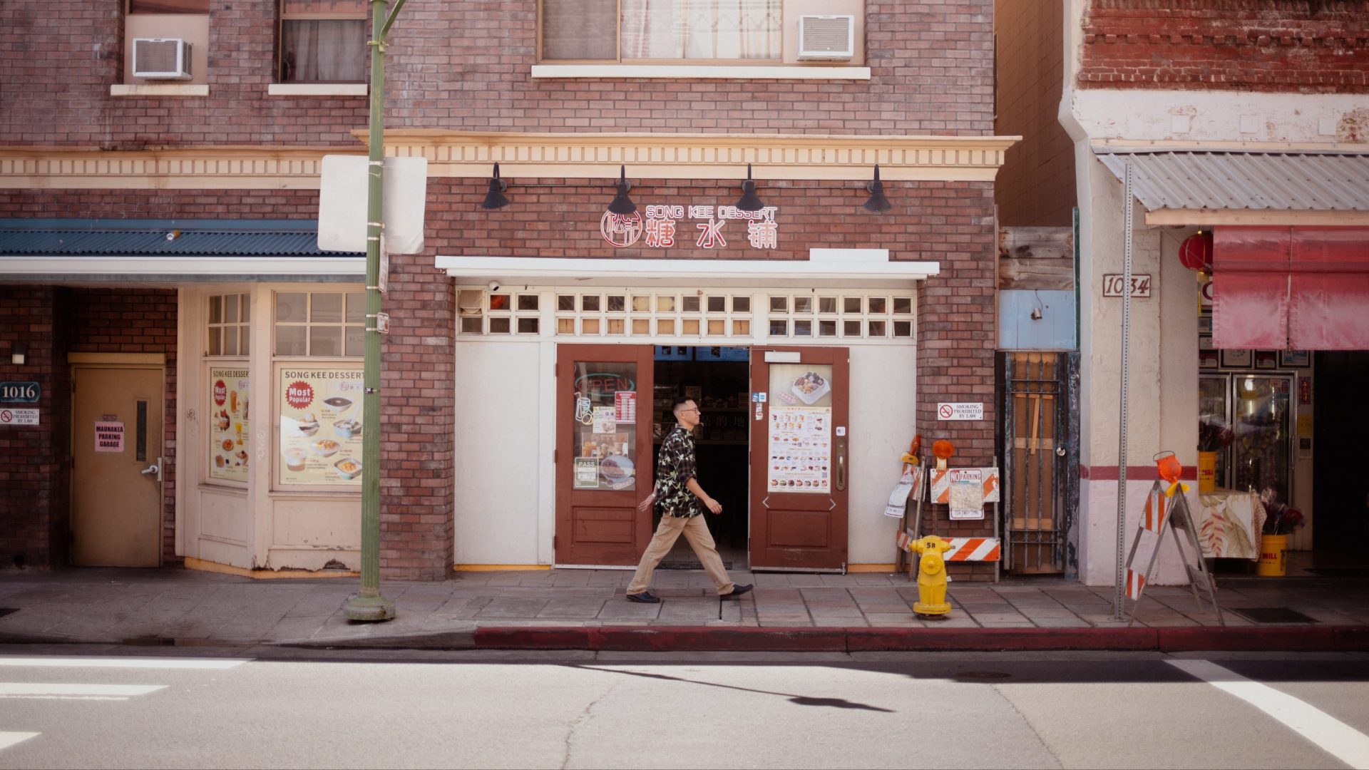 Man walks past brick exterior