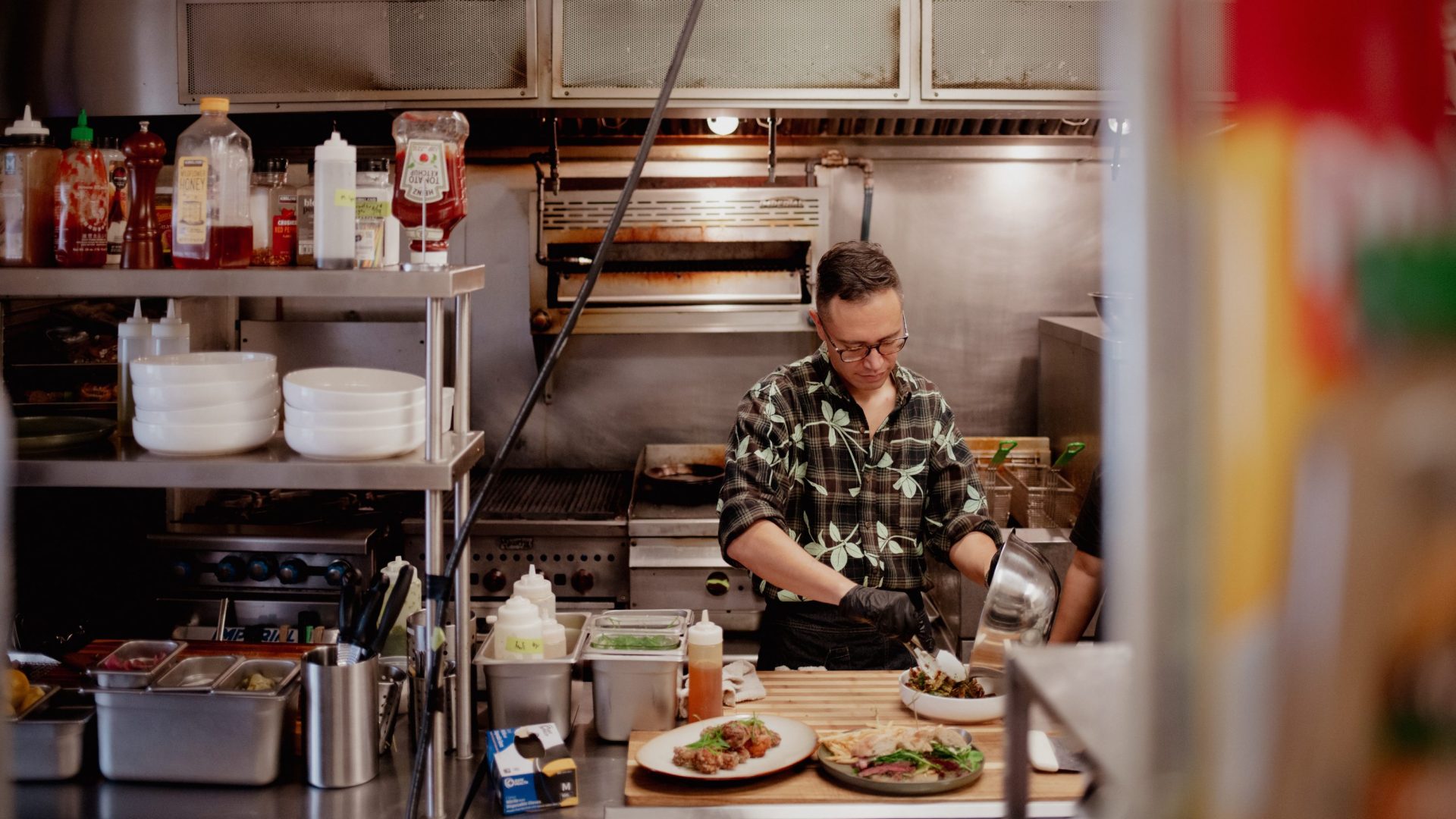 Man prepares food inside commercial kitchen