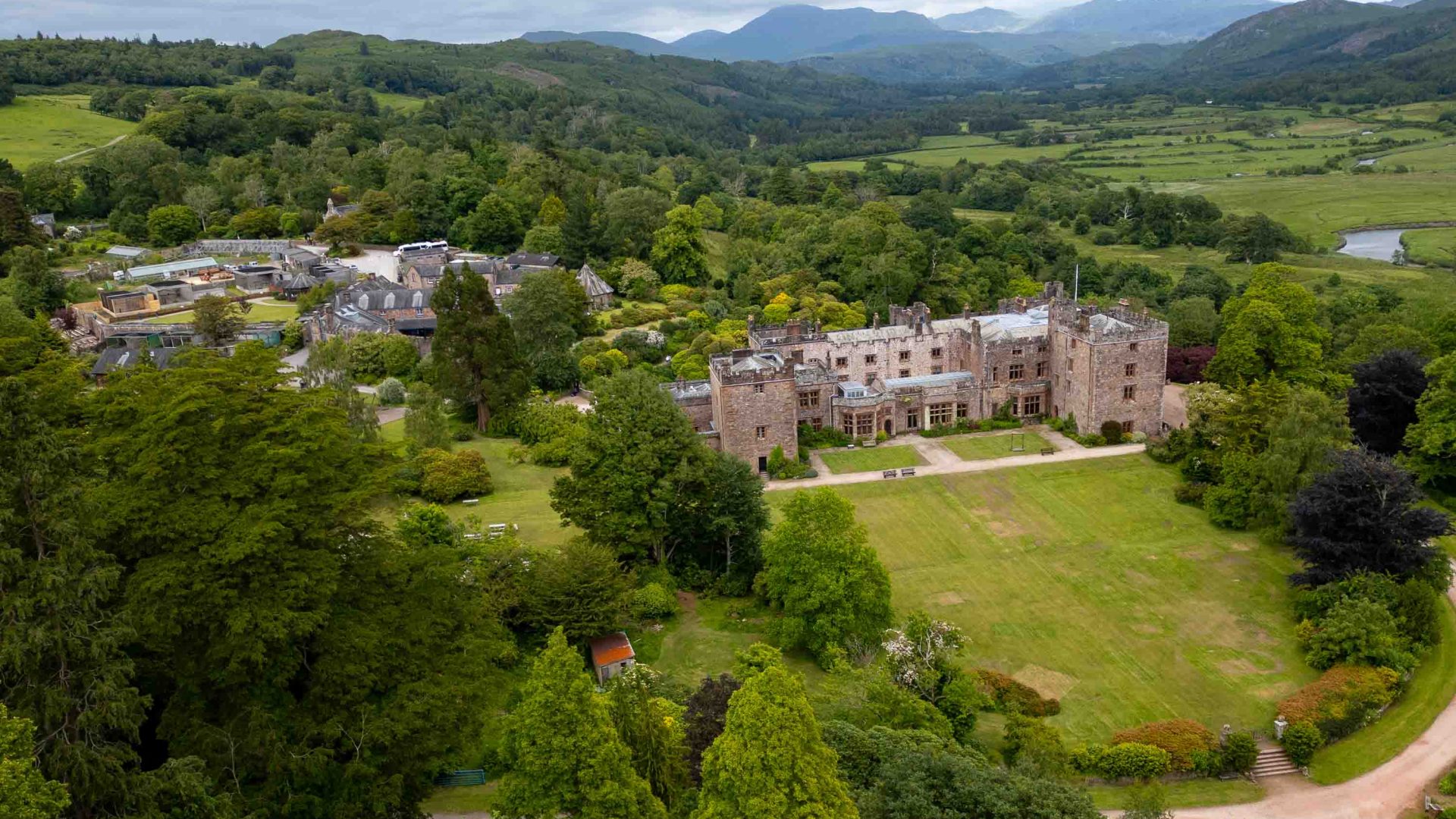 A castle surrounded by green fields and trees.
