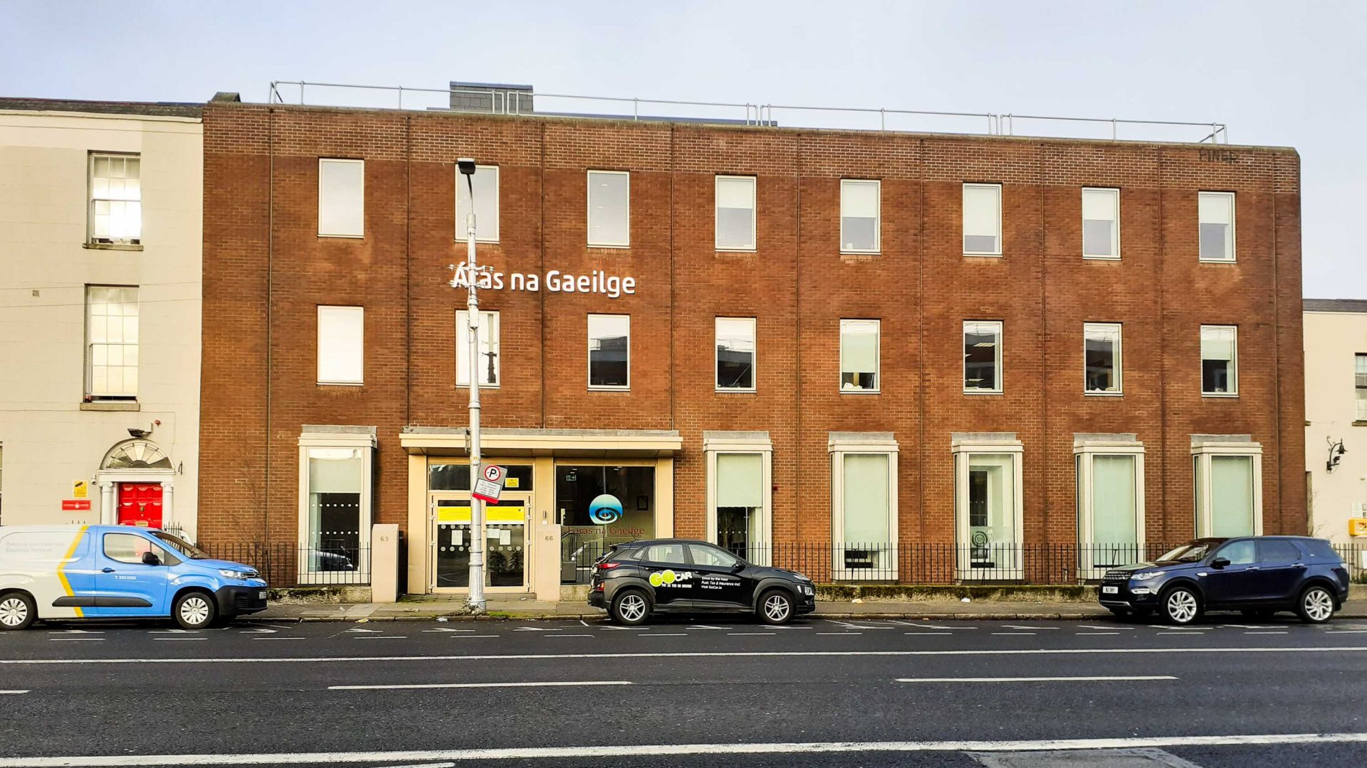 A brick building with the words Foras na Gaeilge on the outside.