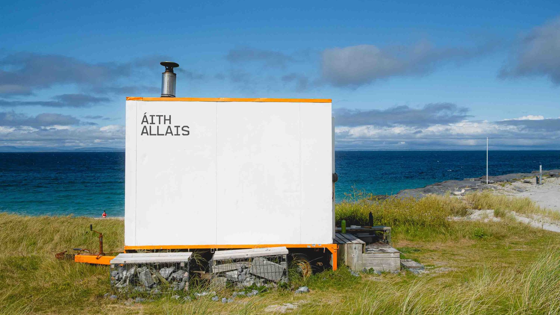 A white sauna by the edge of the sea.