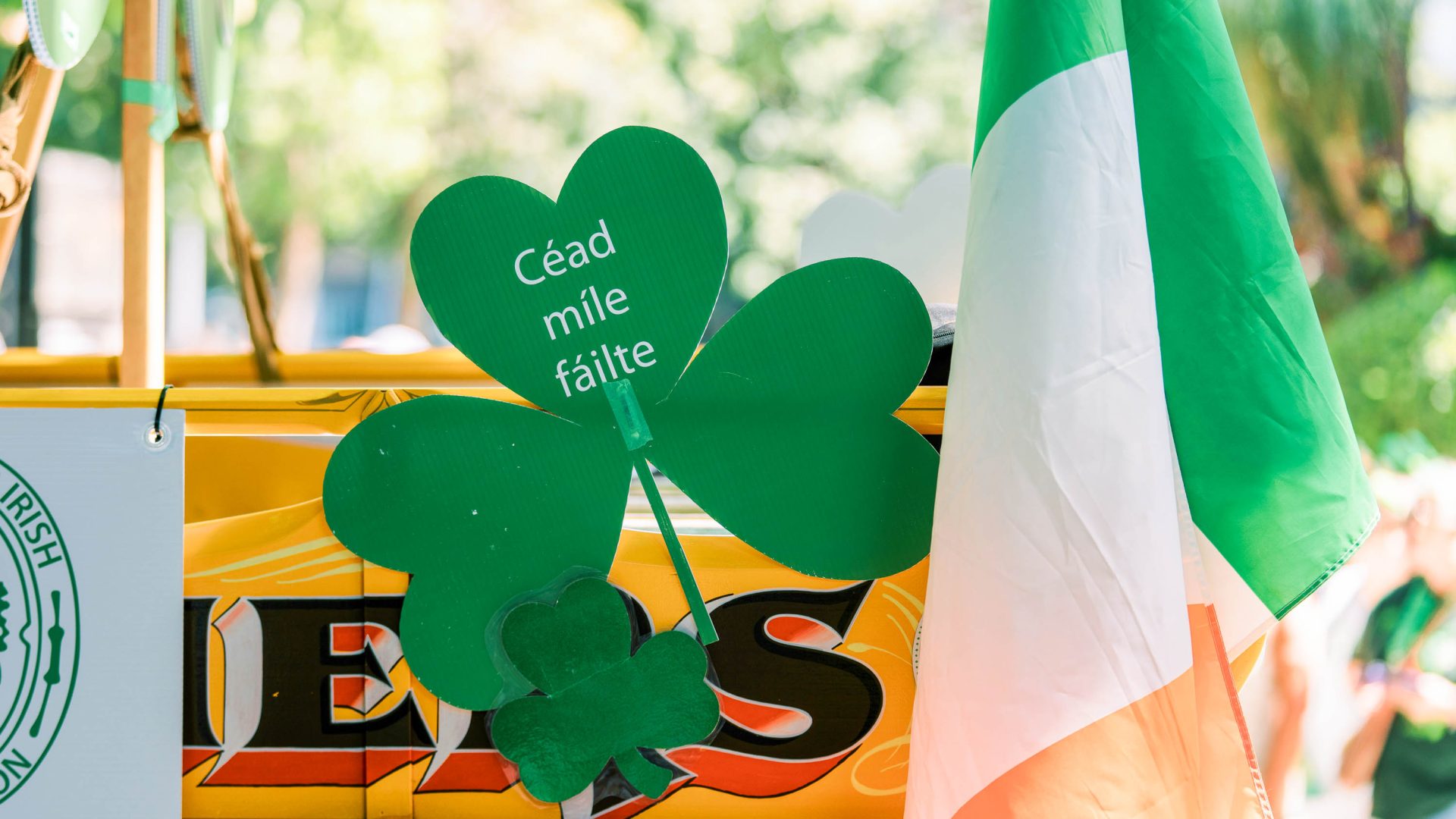 An Irish flag alongside a shamrock cutout with the words "Céad míle fáilte," a classic Gaelic expression meaning "a hundred thousand welcomes."