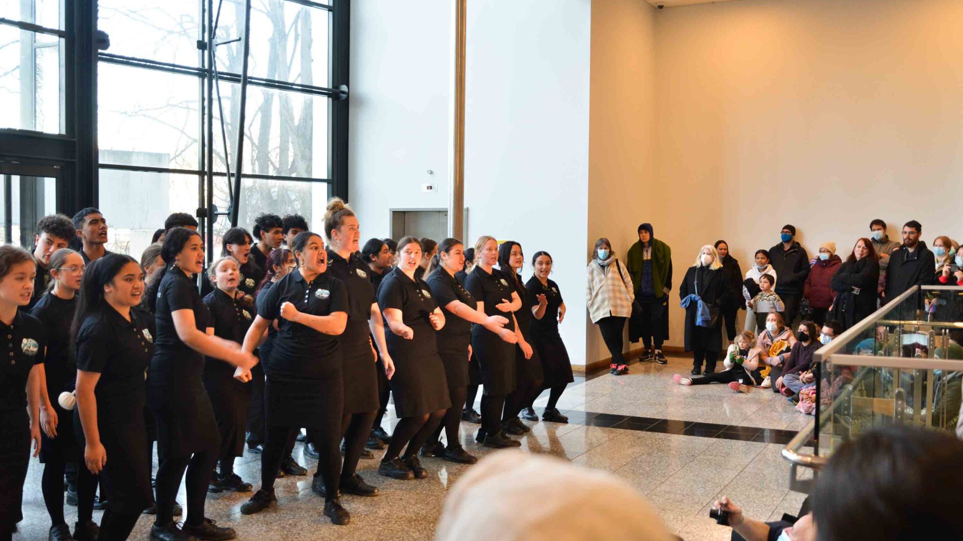 Dancers in black inside a museum.
