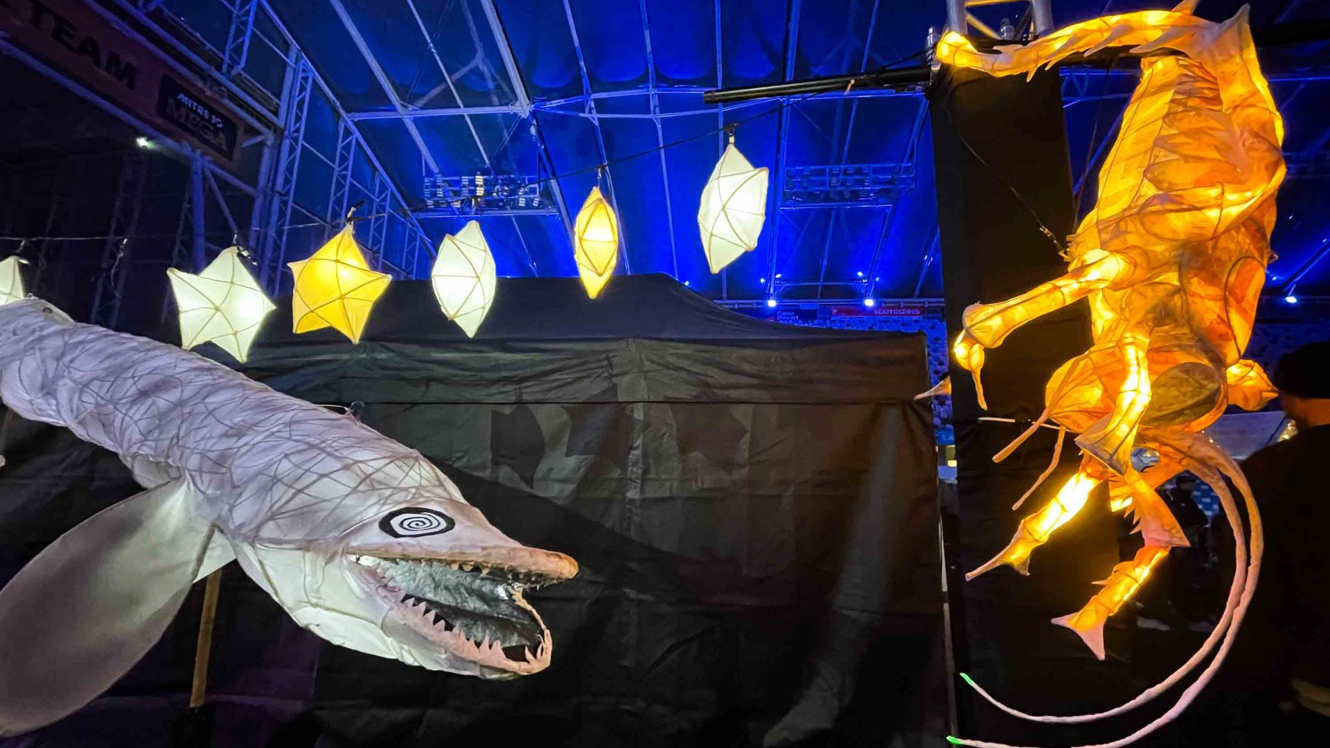 Light lanterns of various animals against blue background.